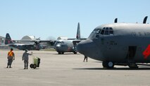 C-130 Hercules maintainers assigned to the 146th Airlift Wing watch on as C-130s taxi in and off the aircraft parking ramp April 28 during the 2010 Modular Airborne Firefighting System certification training in Greenville, S.C. The annually-held certification brought together more than 400 Air National Guard and Air Force Reserve Airmen and their unit's C-130s to receive certification from the U.S. Forest Service in aerial firefighting. The certification runs April 25-May 1. The 146th AW is assigned to the California Air National Guard. (U.S. Air Force photo/Staff Sgt. Stephen J. Collier)