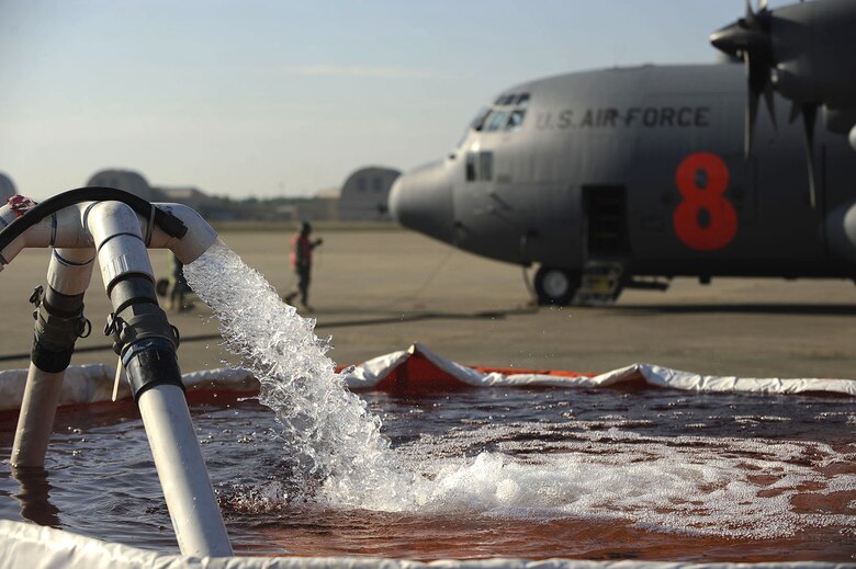 An inflatable tub is filled with water that will be pumped into a C-130 Hercules equipped with a Modular Airborne Firefighting System at the South Carolina Technology and Aviation Center in Greenville, S.C., April 27, 2010. While responding to an actual fire, aircrews flying a MAFFS-equipped C-130 dispense a fire retardant but water is used for training purposes. (U.S. Air Force photo/Staff Sgt. Eric Harris)
