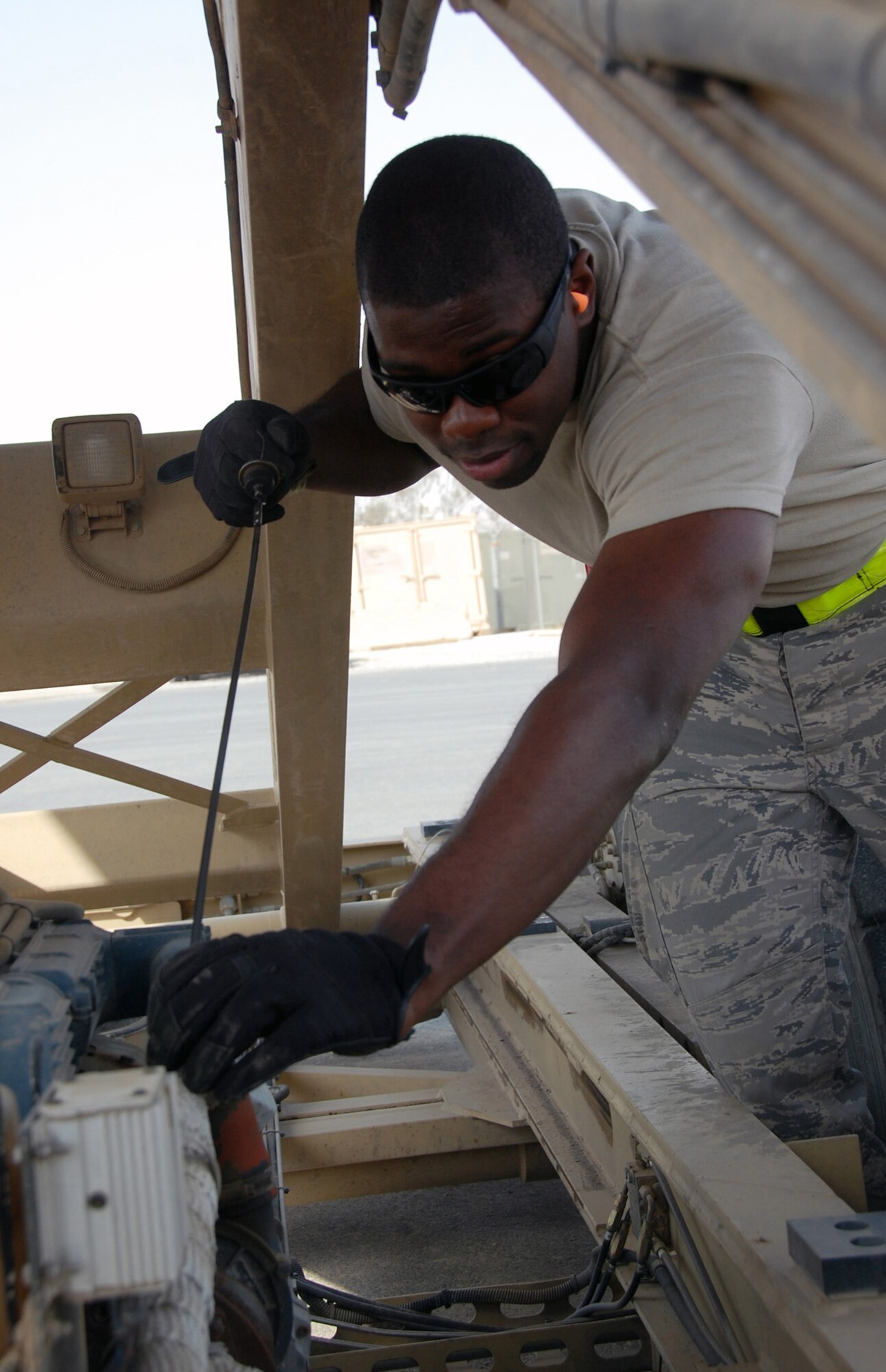 Senior Airman William Jacobs, 386th Expeditionary Logistics Readiness Squadron Aerial Port, inspects a loader April 27 in Southwest Asia. Airman Jacobs is a reservist assigned to the 71st Aerial Port Squadron, Langley Air Force Base, Va. The 71st APS is a geographically separated unit of the 512th Airlift Wing located at Dover Air Force Base, Del. (U.S. Air Force photo/Tech. Sgt. Lindsey Maurice)