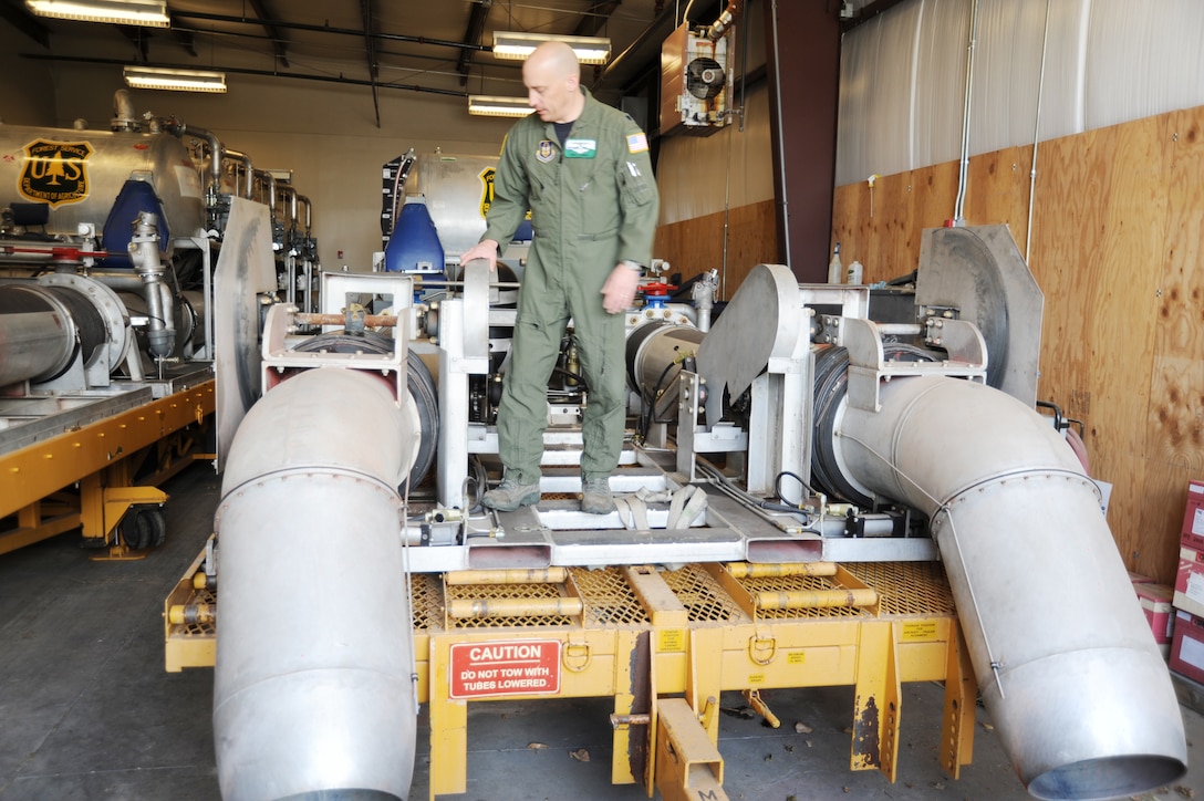 Lt. Col. David Condit, the chief of safety for the 302nd Airlift Wing at Peterson Air Force Base, Colo., and the Air Force Reserve Command’s Modular Airborne Firefighting System coordinator, checks a MAFFS unit.  The unit is rolled into the back of a C-130 Hercules and can disperse up to 3,000 gallons of fire retardant in less than five seconds. The retardant covers an area one-quarter of a mile long and 60 feet wide. (U.S. Air Force photo/Randy Roughton)
