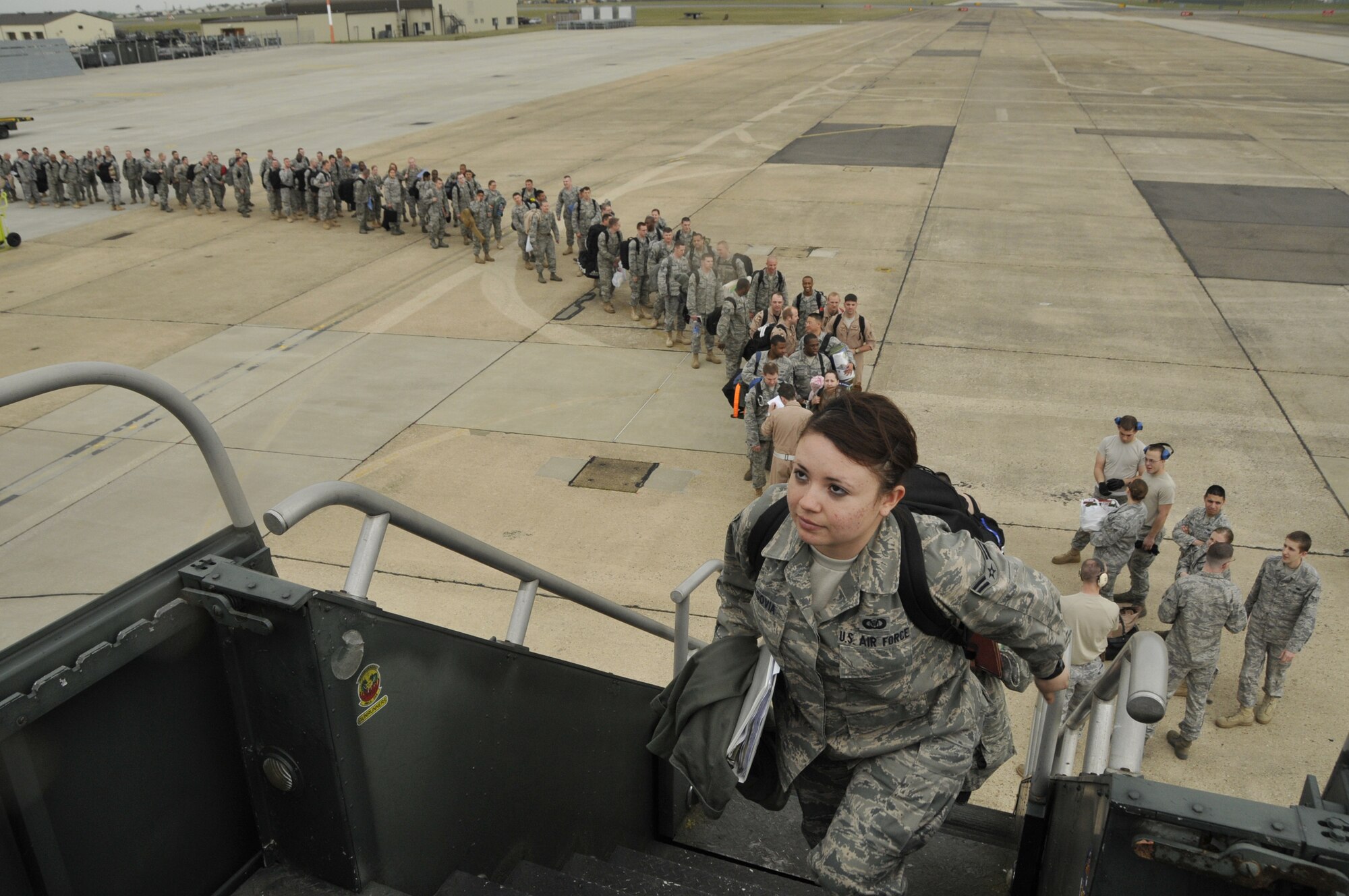 Airman 1st Class Claudia Segovia, 492nd Fighter Squadron, boards a Boeing 737 en route to Bagram Air Base, Afghanistan, in support of Operation Enduring Freedom. Airman Segovia and the Liberty Warriors with her are part of a two-tiered deployment for OEF. (U.S. Air Force photo Airman 1st Class Eboni Knox) 