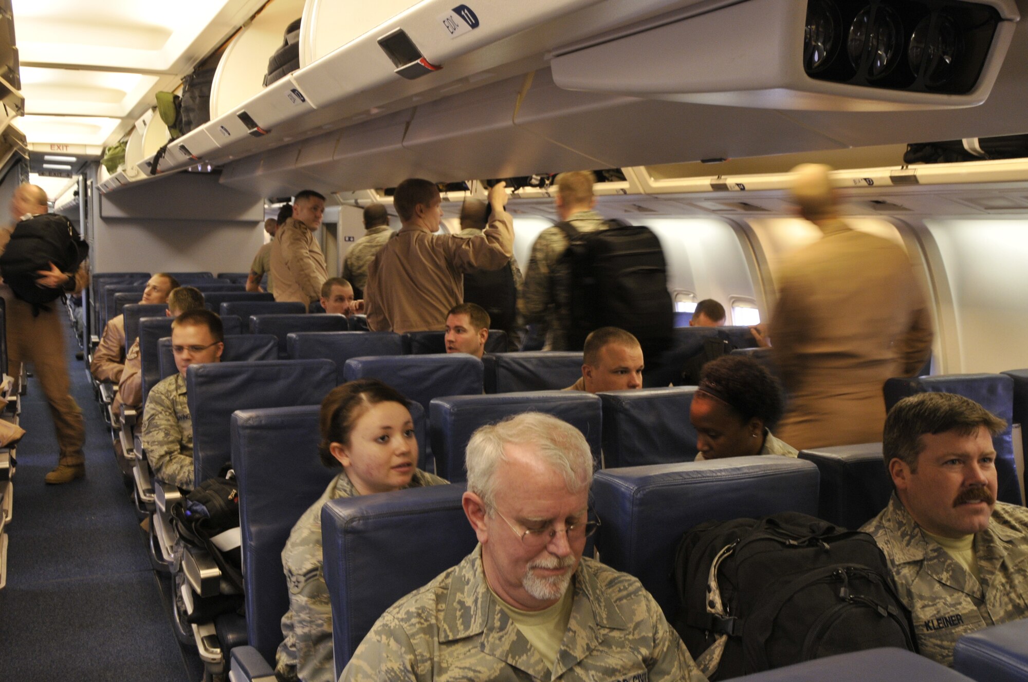 Liberty Warriors settle in for the flight to Bagram Air Base, Afghanistan, in support of Operation Enduring Freedom. The team, comprised of civilians and active duty Airmen, is part of a two-tiered deployment for OEF. (U.S. Air Force photo Airman 1st Class Eboni Knox) - 667
