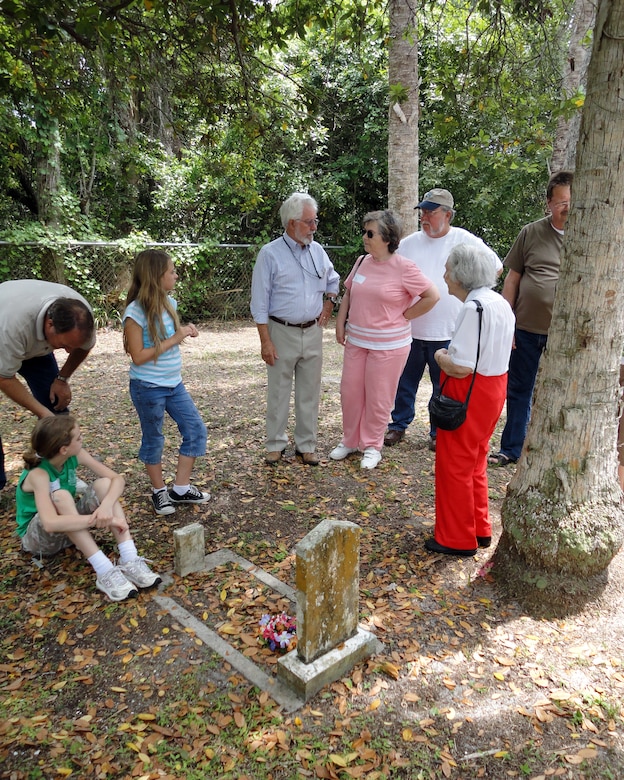 Family members visit the gravesite of Miles Burnham, the first Cape Canaveral Lighthouse keeper during the Descendents Reunion April 24. Accompanying them is Detachment 1, 45th Mission Support Group Director of Operations Sonny Witt (center in blue shirt). (U.S. Air Force photo/Nancy Watts)