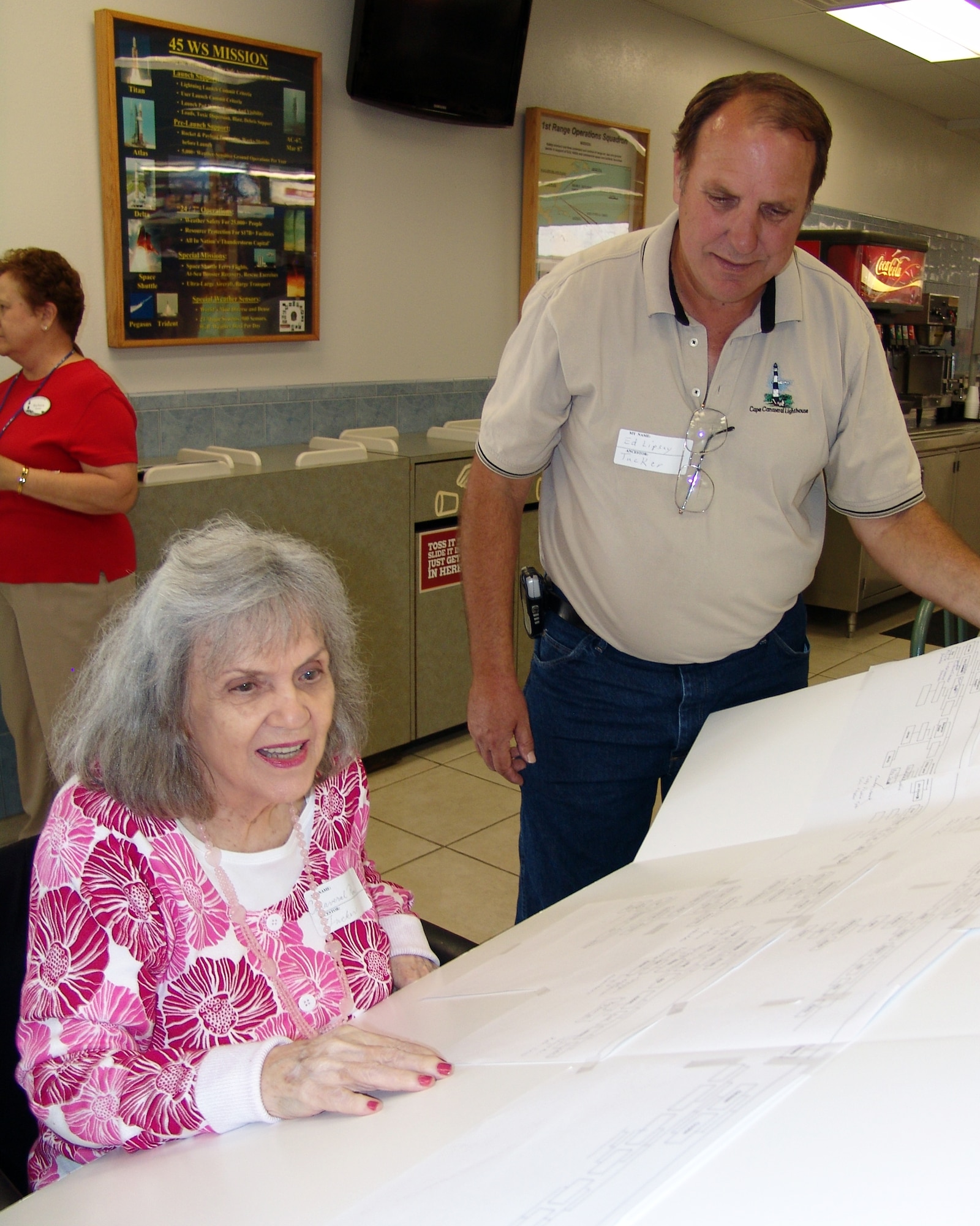 Canaveral Rose Koontz looks over her family tree with son Ed Lipsey at the Descendents Reunion in the Cape Cafeteria April 24. At 85, Canaveral Rose was one of the oldest reunion participants. (U.S. Air Force photo/Nancy Watts)