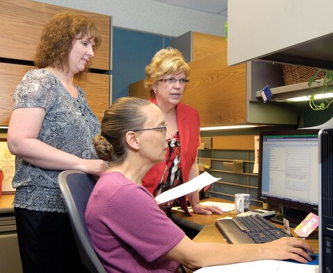At Tinker, PDMC forward demand planners Stacie Acton and Lanora Clark and operations research analyst Diana Moore, from left, focus on multiple customers’ DLA parts requirements. Planning, validating and consolidating requirements in a single demand plan to DLA increases parts supportability and contributes to the flight’s continuing goal of enhancing warfighter support. (Air Force photos by Margo Wright)
