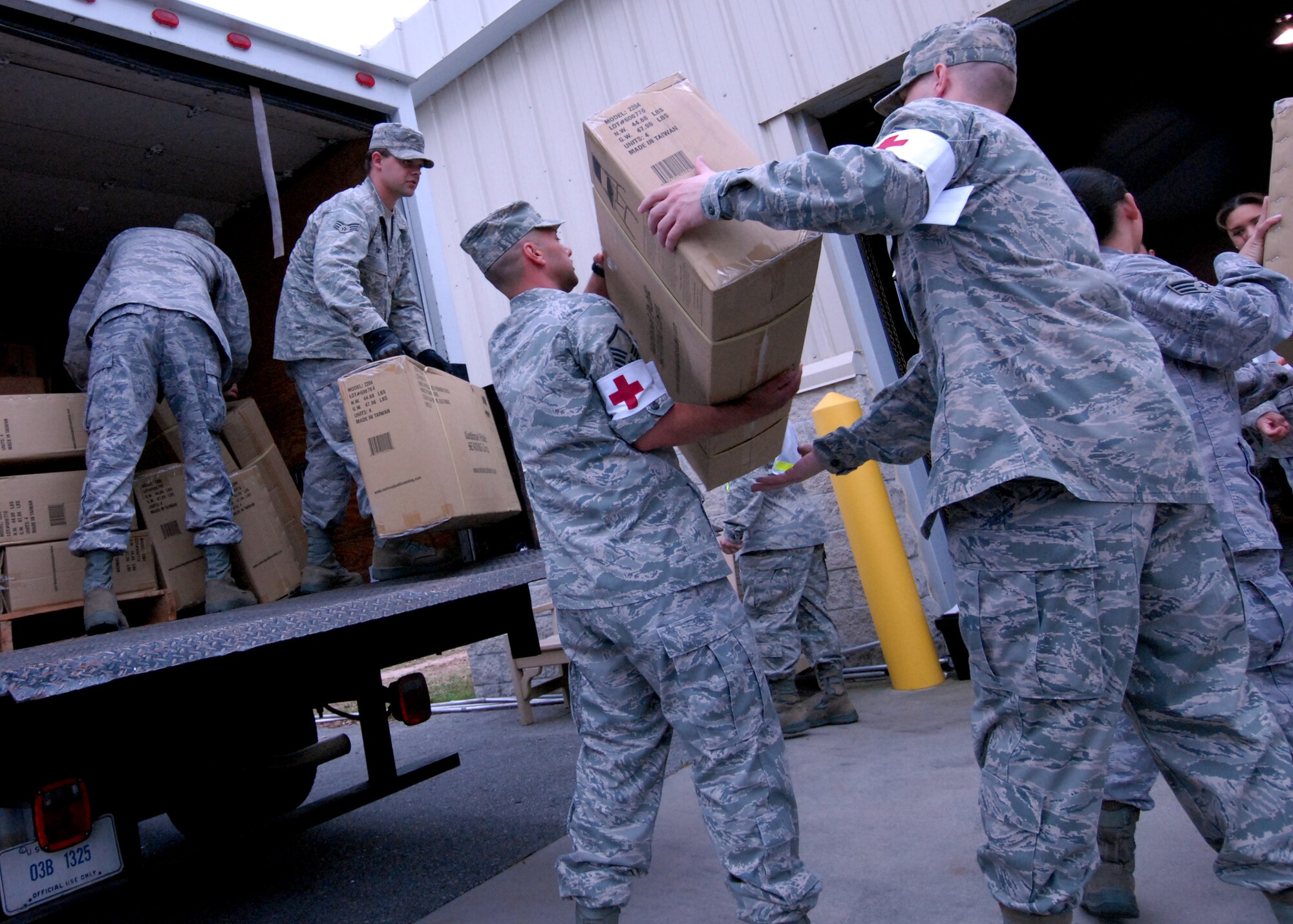 EGLIN AIR FORCE BASE, Fla. – Airmen with the 96th Medical Group form a line passing chairs to set up a triage for plague victims at the Eglin hospital during an exercise April 27. The exercise simulated a naturally occurring outbreak of disease involving pneumonic plague. As a result, the base hospital became the main triage site where medical personnel diagnosed the potentially infected. Patients identified as infected were isolated to prevent further spread of the pandemic and for additional surveillance. These exercises are conducted at Eglin to maintain constant mission and emergency readiness. (U.S. Air Force photo/ Airman 1st Class Anthony Jennings)