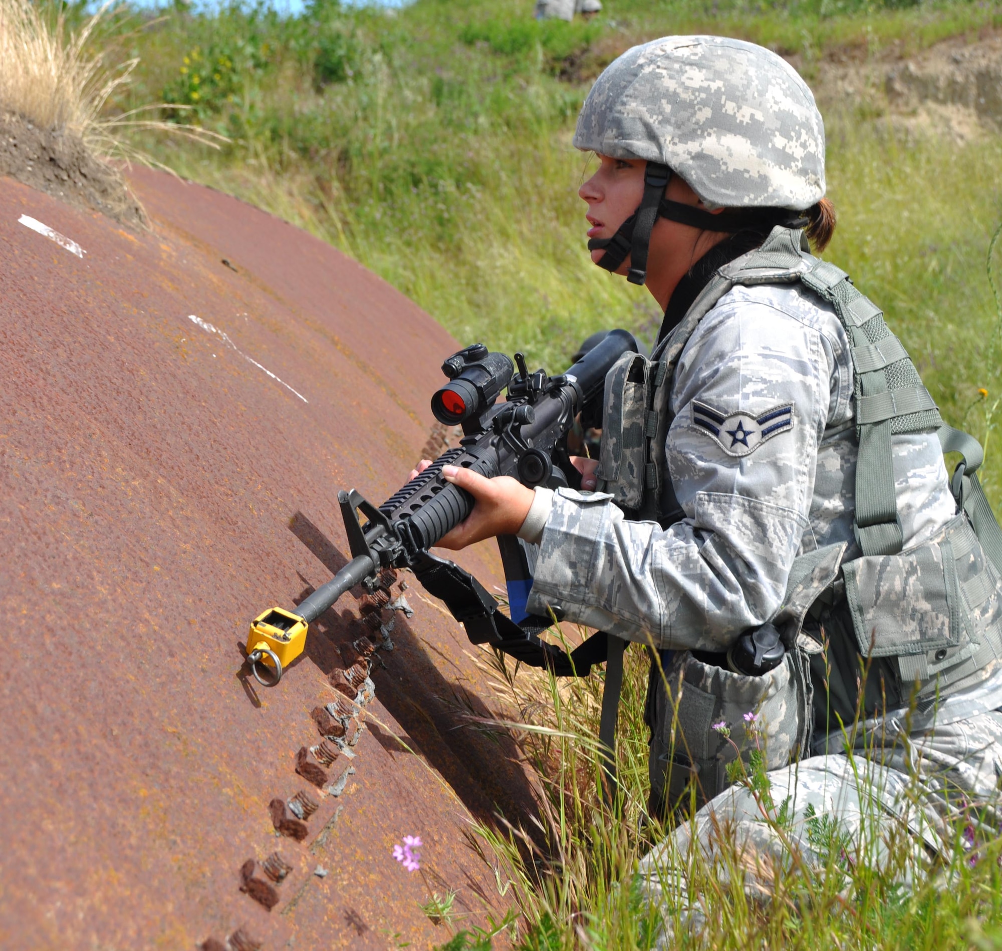 Airman 1st Class Tera Eckert, 60th Security Forces Squadron patrolman, uses an old structure as cover while she surveys the land for enemy insurgents during an exercise at Camp Park Reserve Force Training Area in Dublin, Calif. (U.S. Air Force photo/Airman 1st Class Michael Battles)
