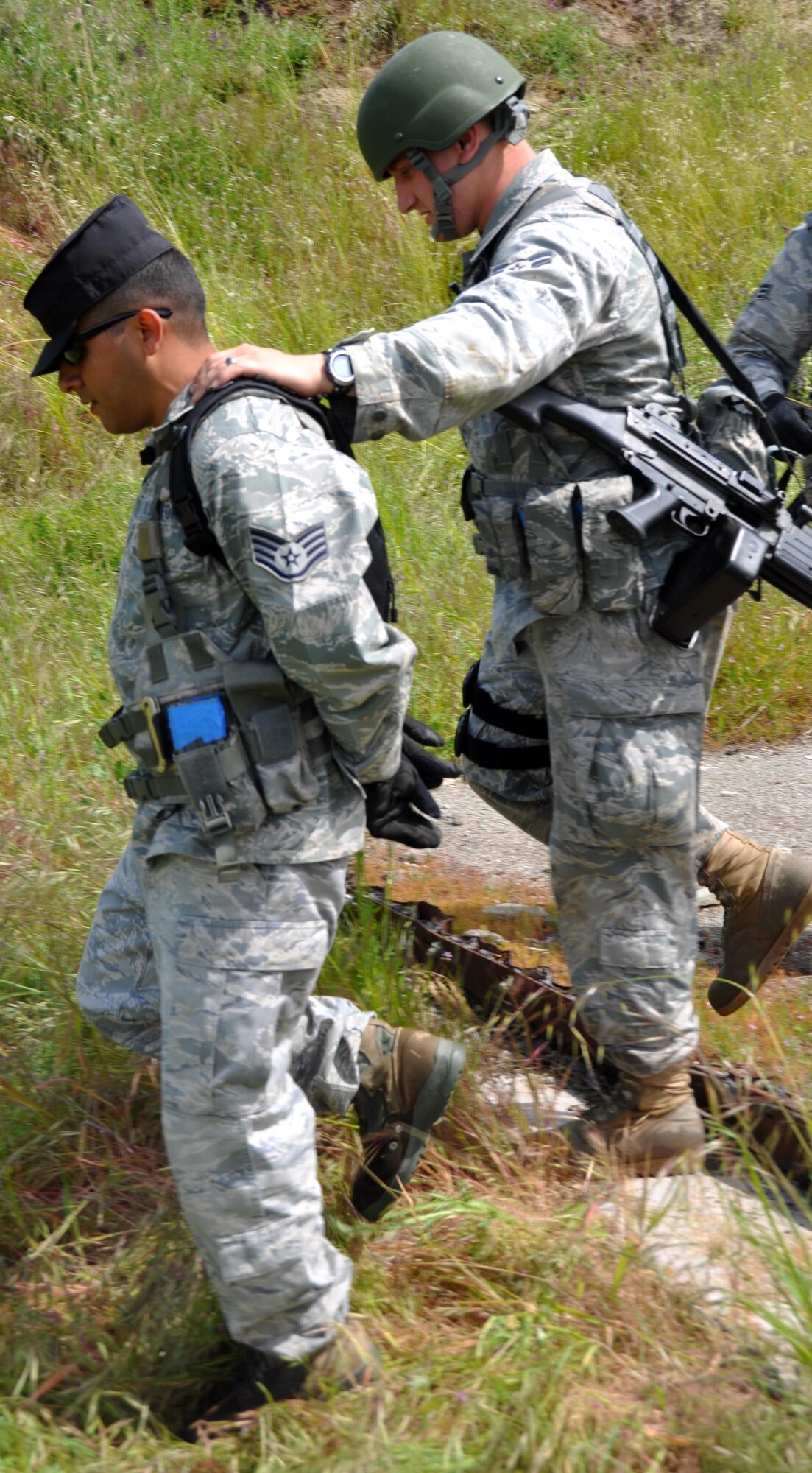 Airman 1st Class Luke Severns, 60th Security Forces Squadron, escorts Staff. Sgt Julian Cantu down the mountain after being captured by security forces during an exercise at Camp Park Reserve Force Training Area in Dublin, Calif. Sergeant Cantu was acting as an insurgent during the exercise. (U.S. Air Force photo/Airman 1st Class Michael Battles)