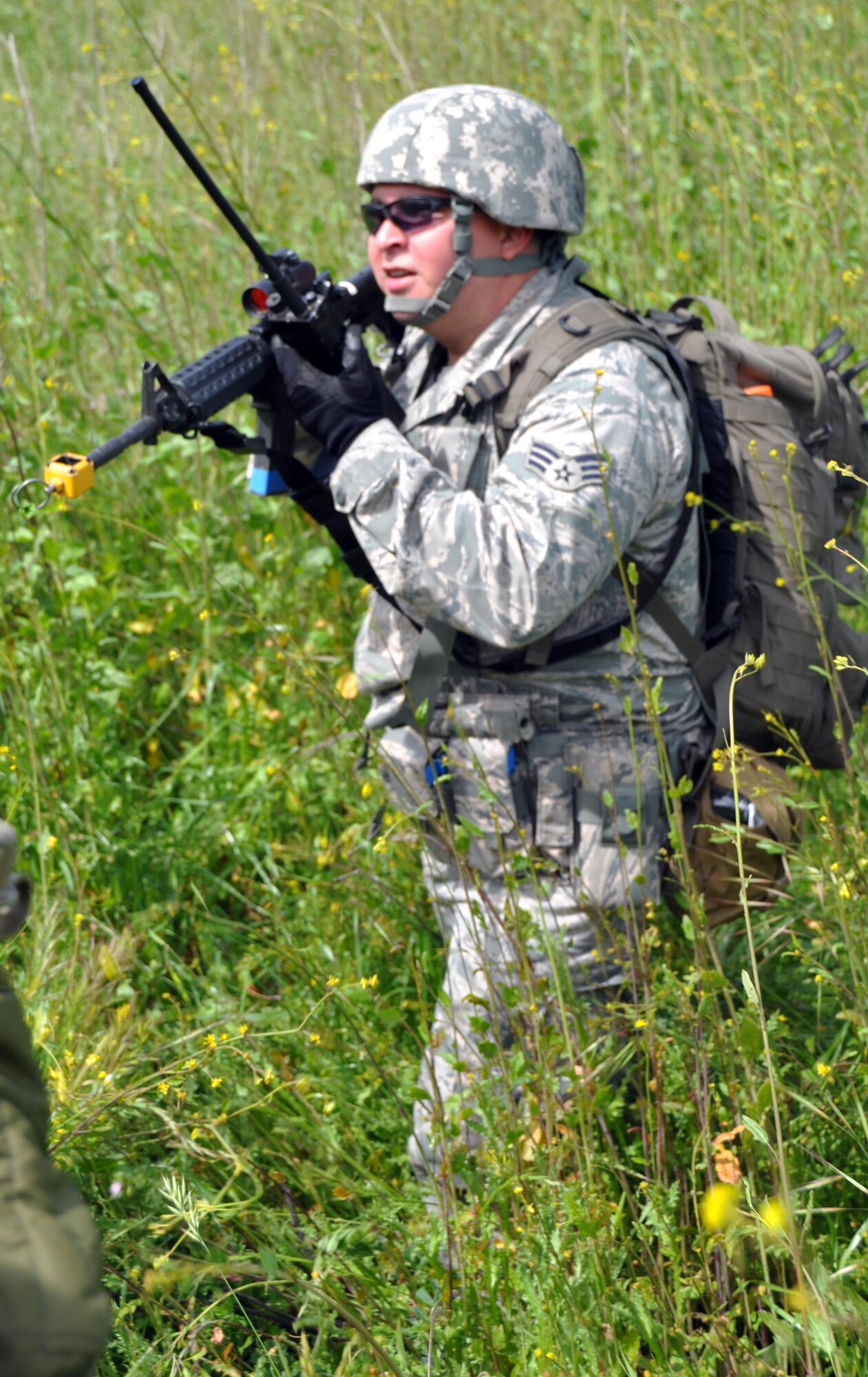 Senior Airman Juan Gonazalez, 60th Security Forces Squadron patrolman, surveys the land and transmits radio locations during a weeklong exercise at Camp Park Reserve Force Training Area in Dublin, Calif. (U.S. Air Force photo/Airman 1st Class Michael Battles)
