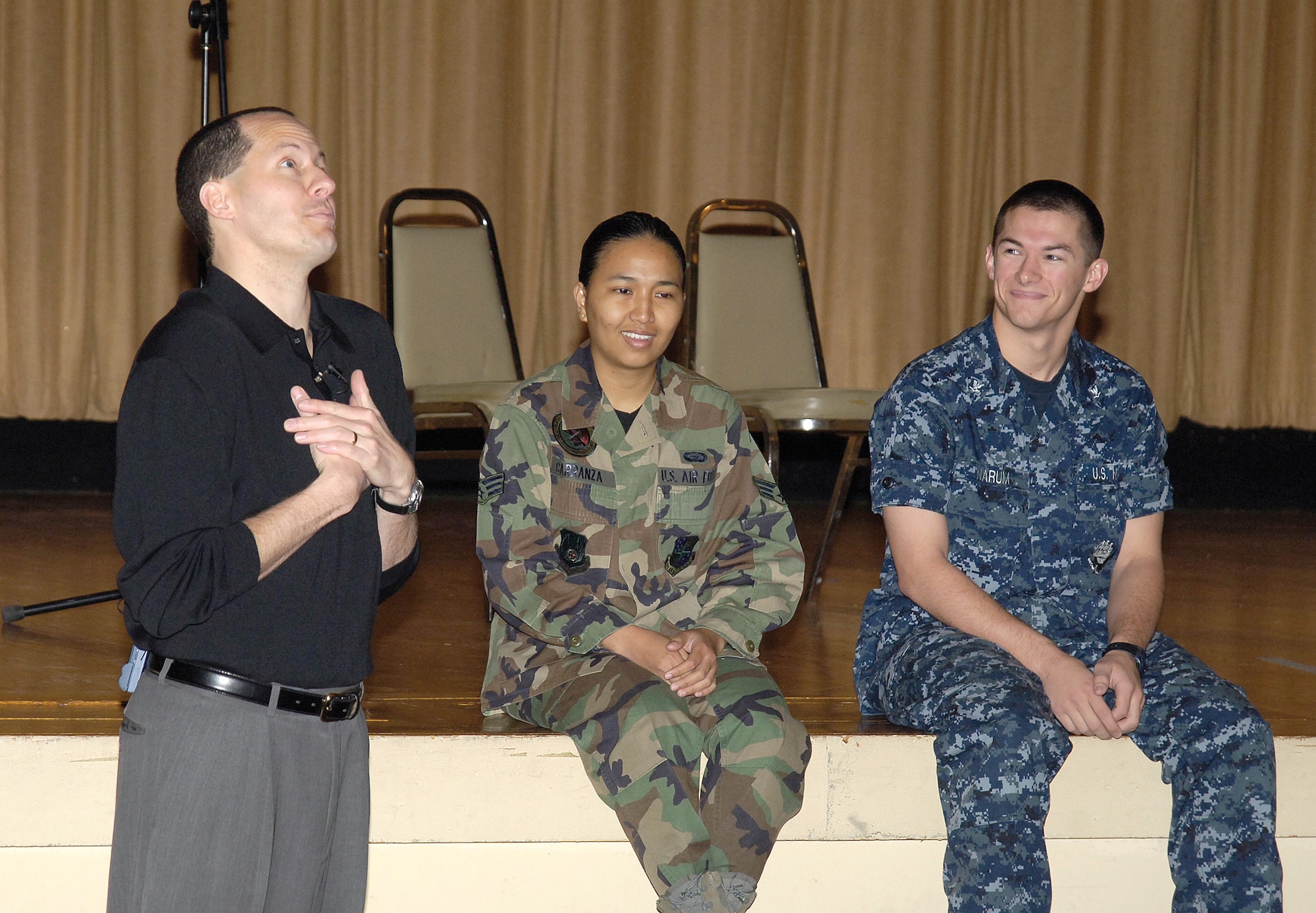 Senior Airman PiaLuna Carranza, 72nd Air Base Wing Force Support Squadron,  and Petty Officer 3rd Class Jacob Narum, Fleet Air Reconnaissance Squadron FOUR,  role play with Mike Domitrz during the first presentation of “Can I Kiss You?”  held April 27 at the base theater.  Sponsored by Tinker’s Sexual Assault Prevention and Response program, the show presented the seriousness of sexual and domestic violence in an informal way. (Air Force photo by Margo Wright)