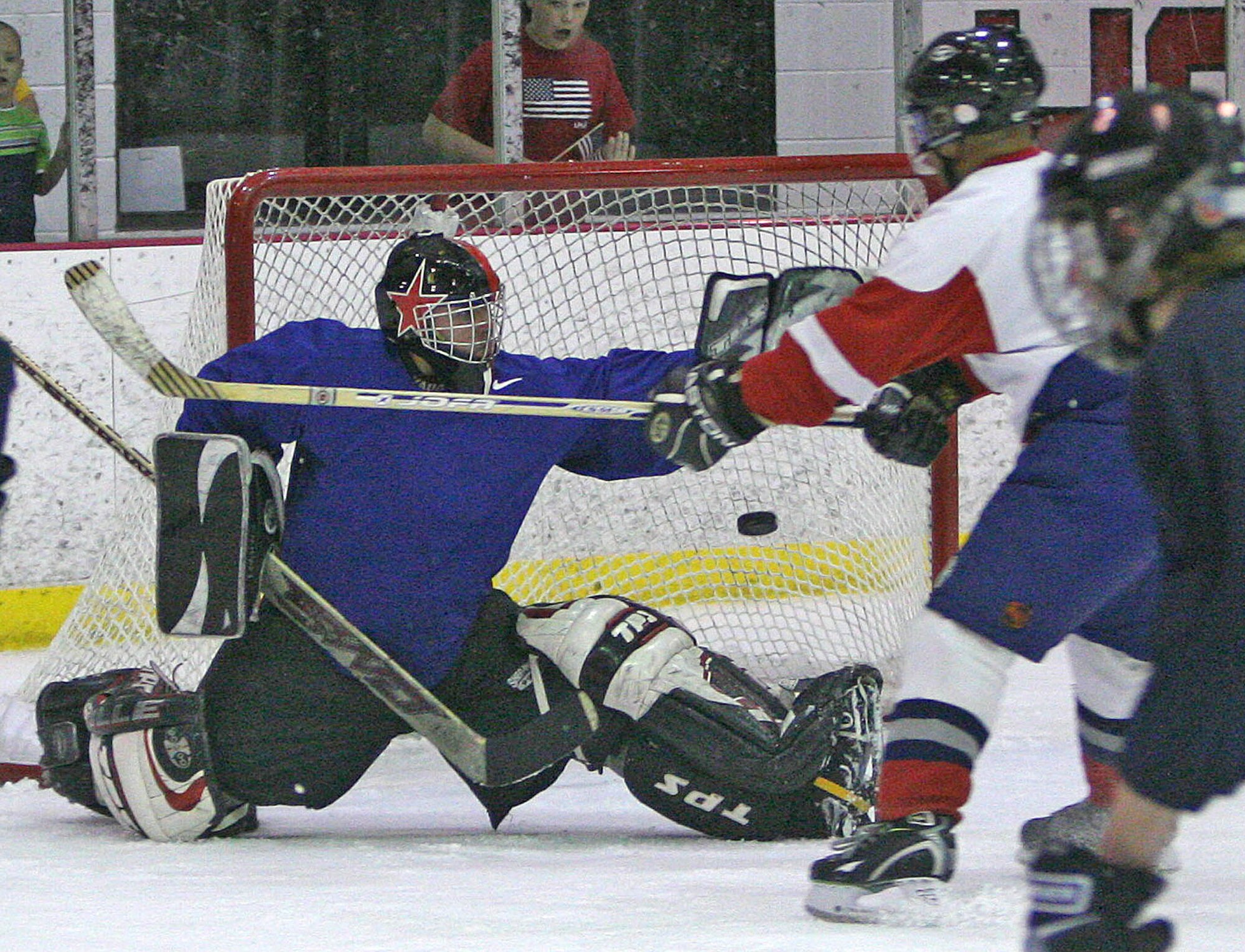 American goalie Jeffrey Migdal bobbles the catch off Canadian Steve Retieffe’s shot April 23 during the second annual 552nd Air Control Wing Can Am Cup. The dual-nation co-workers squared off Friday in a match that ended 6-5 in Canada’s favor following a harrowing shootout finish. The game brought in a crowd of more than 500 and the series is now tied at 1-1. (Air Force photos by John Stuart)