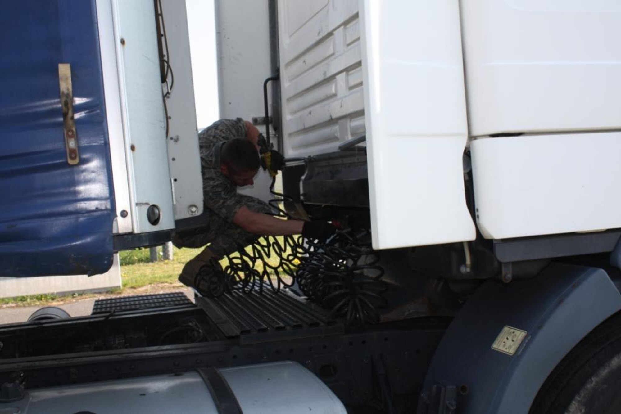 Senior Airman Phillip Rictor, 485th Intelligence Squadron traffic management journeyman, connects a 40-foot trailer to a 10-ton truck in preparation to pick up equipment at Ramstein Air Base, Germany. The truck is used to transport critical equipment throughout Europe. (U.S. Air Force photo by Master  Sgt. Joselito Papa)