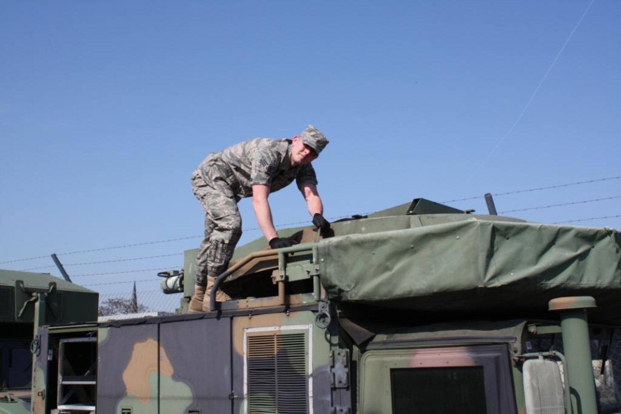 Senior Airman Phillip Rictor, 485th Intelligence Squadron traffic management journeyman, prepares a Humvee for transfer to the Army National Guard. (U.S. photo by Master Sgt. Joselito Papa)