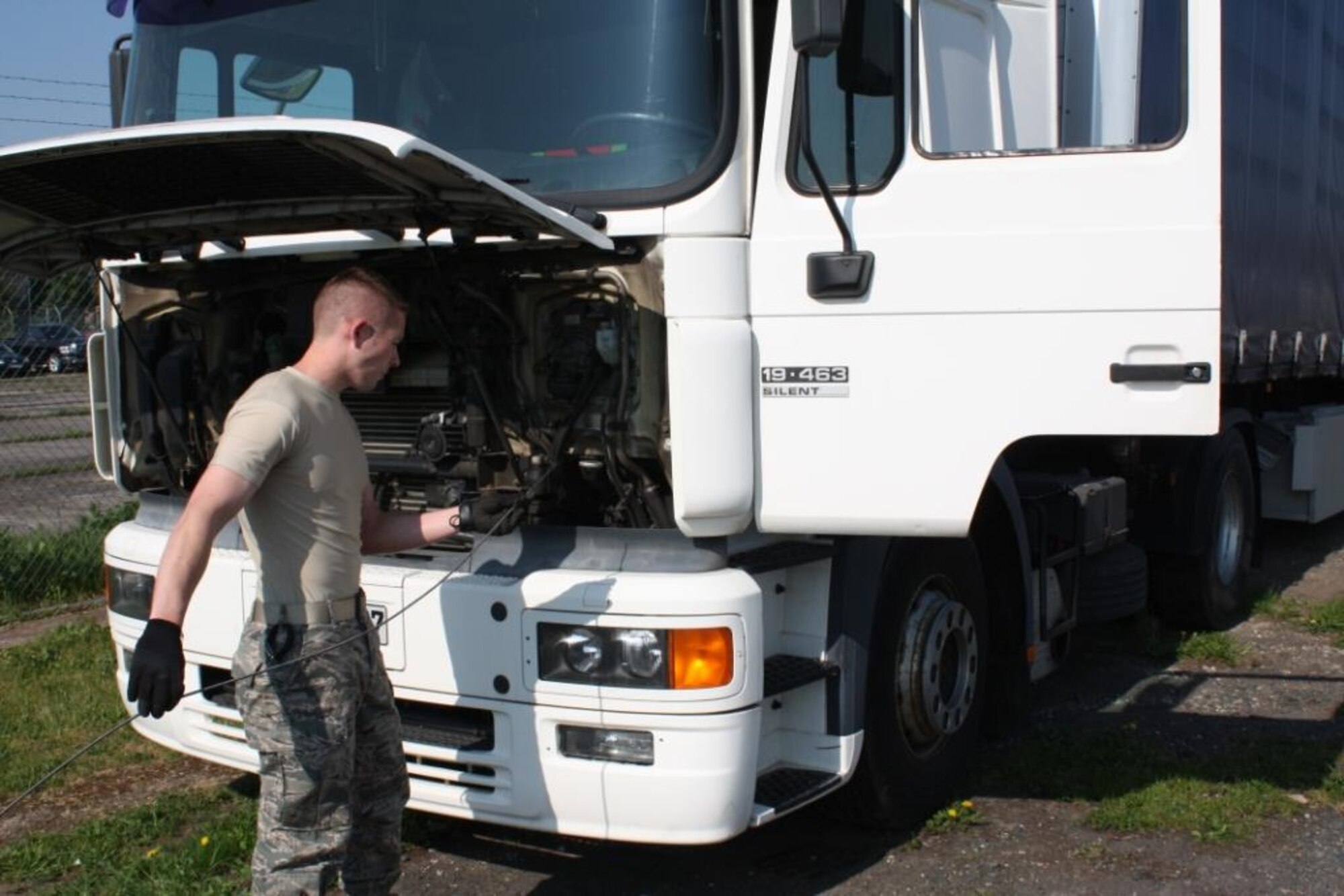 Senior Airman Phillip Rictor, 485th Intelligence Squadron traffic management journeyman, checks the oil on a  10-ton truck as part of routine maintenance at Ramstein Air Base, Germany. The truck is used to transport critical equipment throughout Europe. (U.S. Air Force photo by Master  Sgt. Joselito Papa)