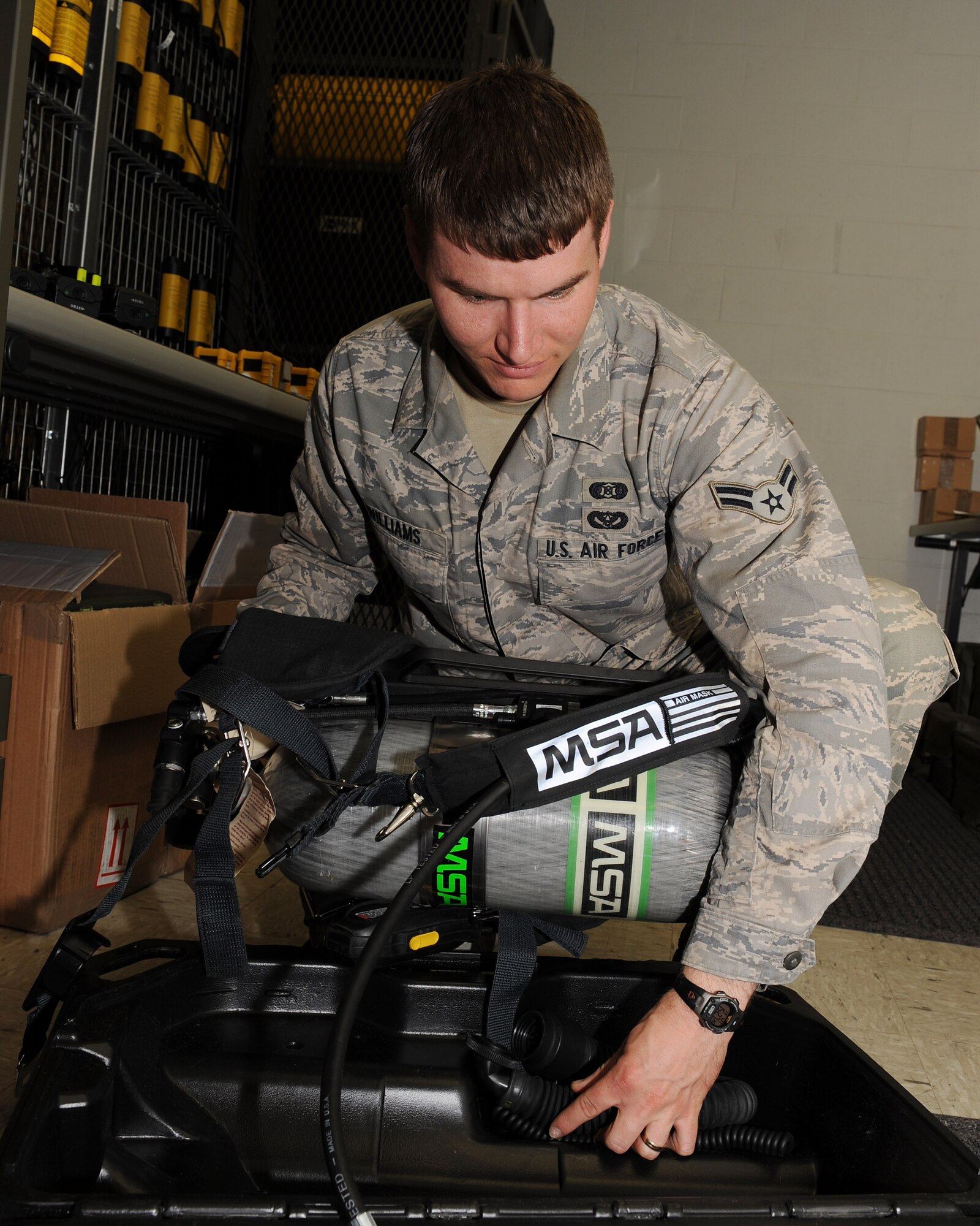 Airman 1st Class Nathan Williams, 19th Civil Engineer Squadron readiness apprentice, removes a self contained breathing apparatus from a case April 23 to perform an operations check. Airman Williams designed the first Little Rock Air Force Base response guide and streamlined 31 checklist items to facilitate the commander’s emergency operations center activation in less than 15 minutes. (U.S. Air Force photo by Staff Sgt. Chad Chisolm)