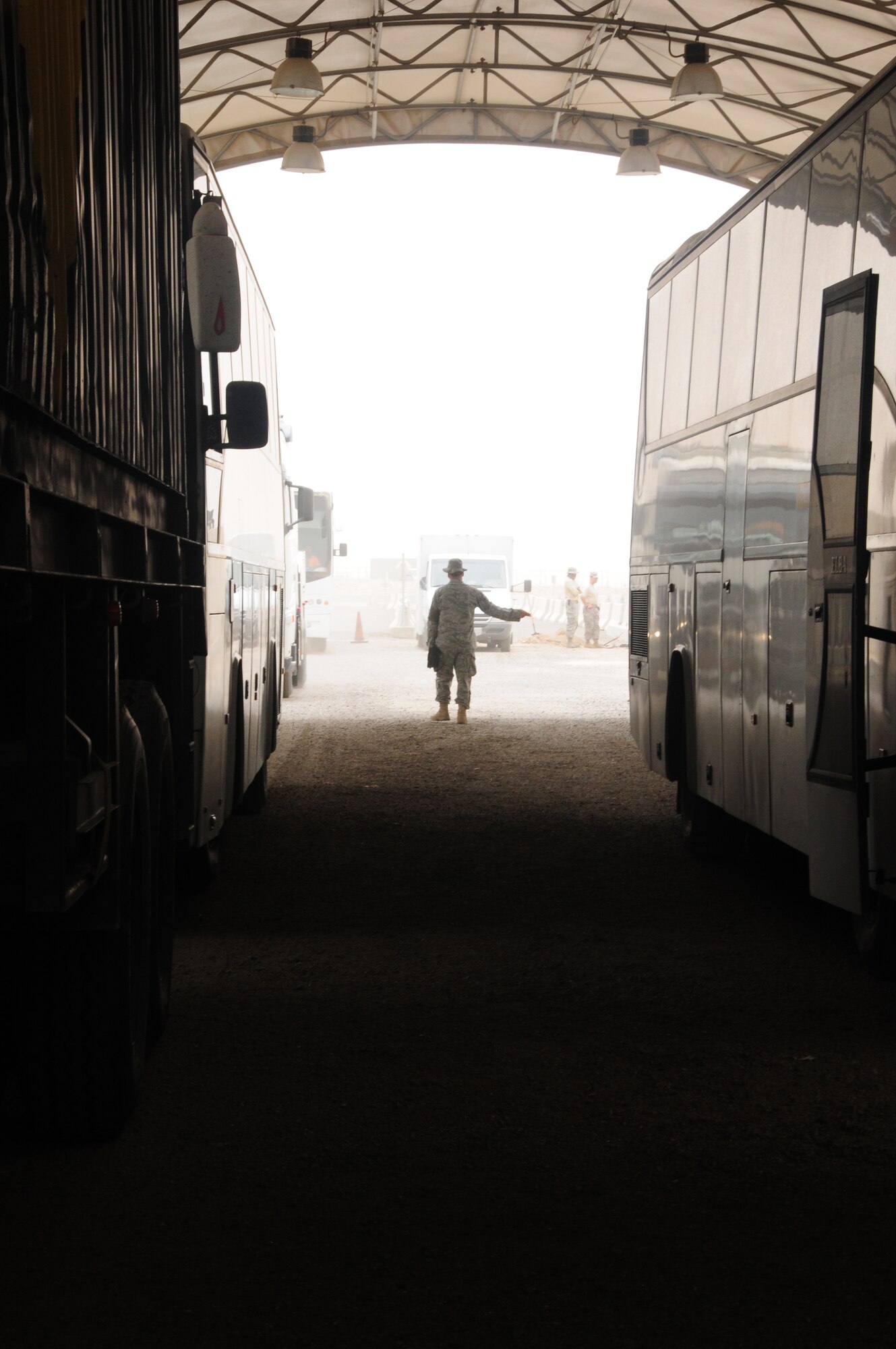 Members of the 387th Expeditionary Security Forces Squadron prepare to inspect contract vehicles before allowing them to enter an undisclosed air base in Southwest Asia April 23, 2010. (U.S. Air Force photo by Staff Sgt. Lakisha A. Croley/Released)