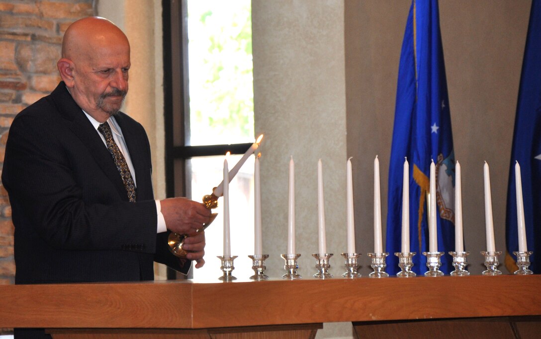 Lighting candles in remembrance of Jewish Holocaust victims, Mr. Paul Kessler, of the Dallas Holocaust Museum, was the guest speaker at Sheppard's Remembrance Service at the north Chapel April 28, 2010. The 11 candles represent the groups of victims that were killed during the Holocaust, including Jews, upstanders, victims who were the mentally or physically disabled, the Roma people, the Slavic people and the political prisoners.  (U.S. Air Force Photo/Airman 1st Class Adawn Kelsey)