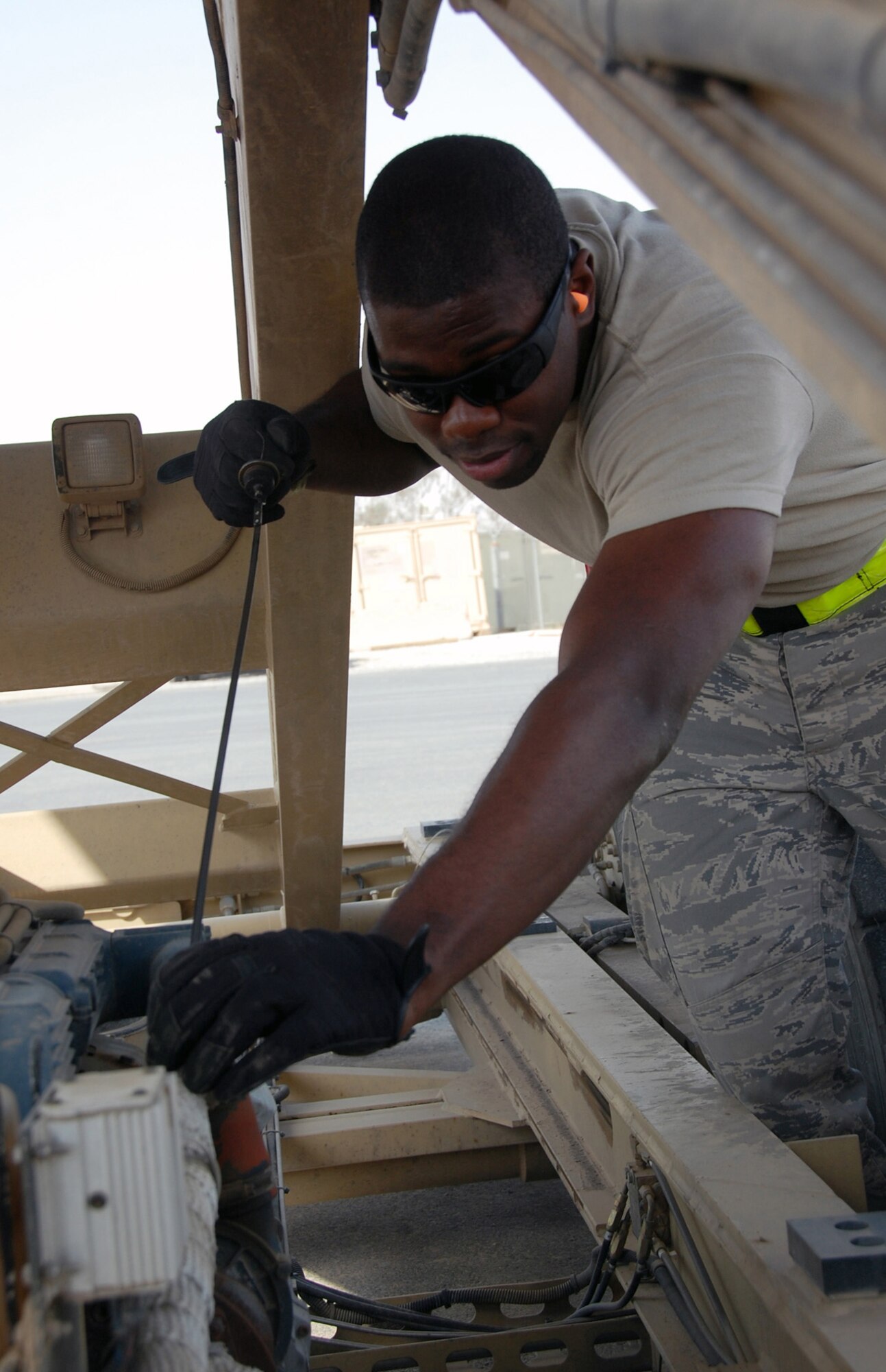 U.S. Air Force Senior Airman William Jacobs of the 386th Expeditionary Logistics Readiness Squadron Aerial Port performs a daily inspection on a NGSL loader April 27, 2010 at an undisclosed location in Southwest Asia. The Aerial Port team works around the clock, processing an average of 60,000 passengers and five and a half tons of cargo in and out of the U.S. Central Command area of responsibility a month. 
(U.S. Air Force photo by Tech. Sgt. Lindsey Maurice/Released)