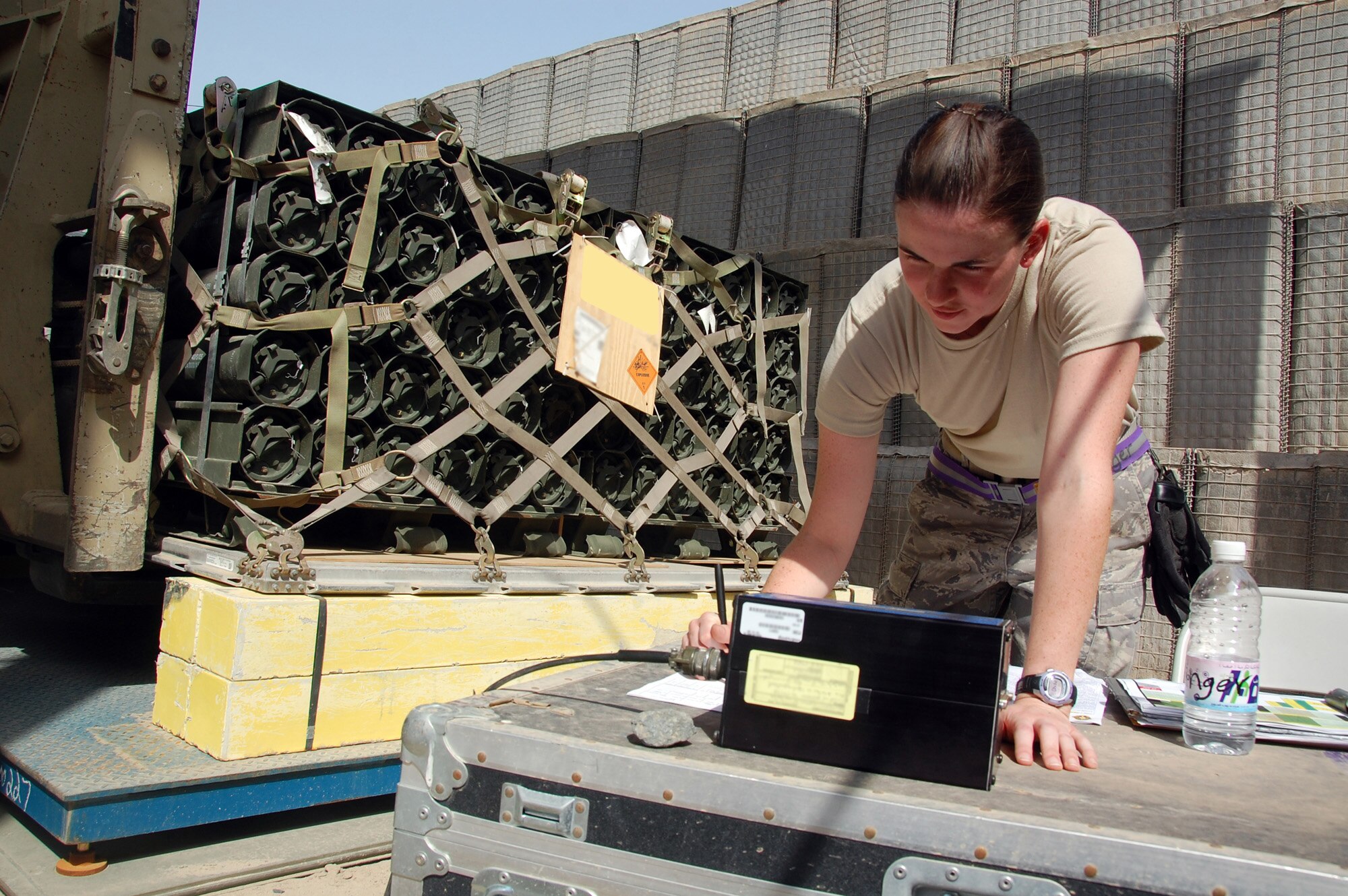 U.S. Air Force Senior Airman Jennifer Pottinger of the 386th Expeditionary Logisitcs Readiness Squadron Aerial Port inprocesses a 463L pallet of ammuntion April 27, 2010 at an undisclosed location in Southwest Asia. The 386th ELRS Aerial Port team works around the clock, processing an average of 60,000 passengers and five and a half tons of cargo in and out of the U.S. Central Command area of responsibility a month.(U.S. Air Force photo illustration by Tech. Sgt. Lindsey Maurice/Released) 
