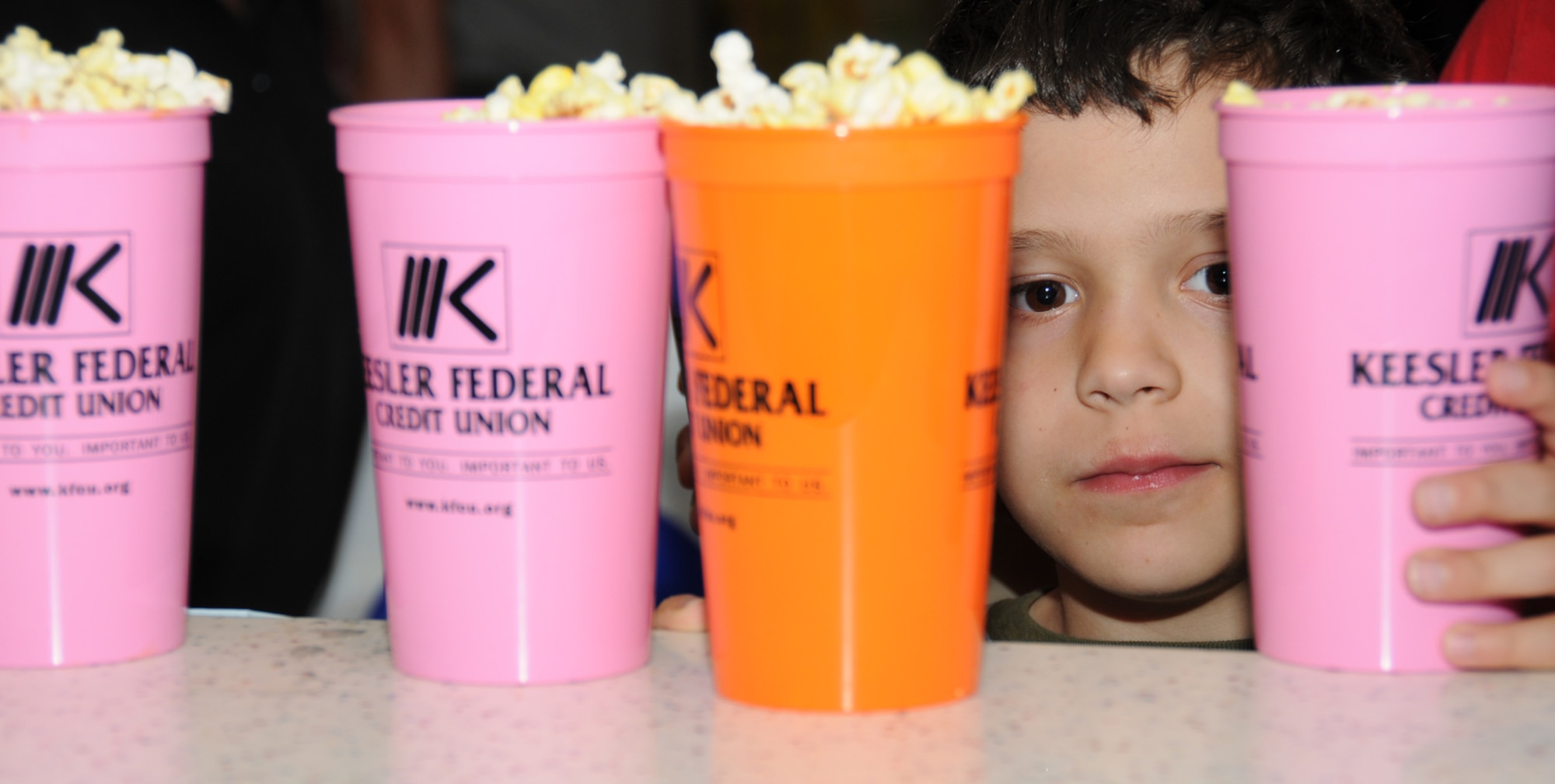 Nine-year-old David Alexander, son of retired Maj. Ronald and Mireya Alexander, helps himself to some popcorn during Child Pride Day, April 24 at the youth center.  (U.S. Air Force photo by Kemberly Groue)