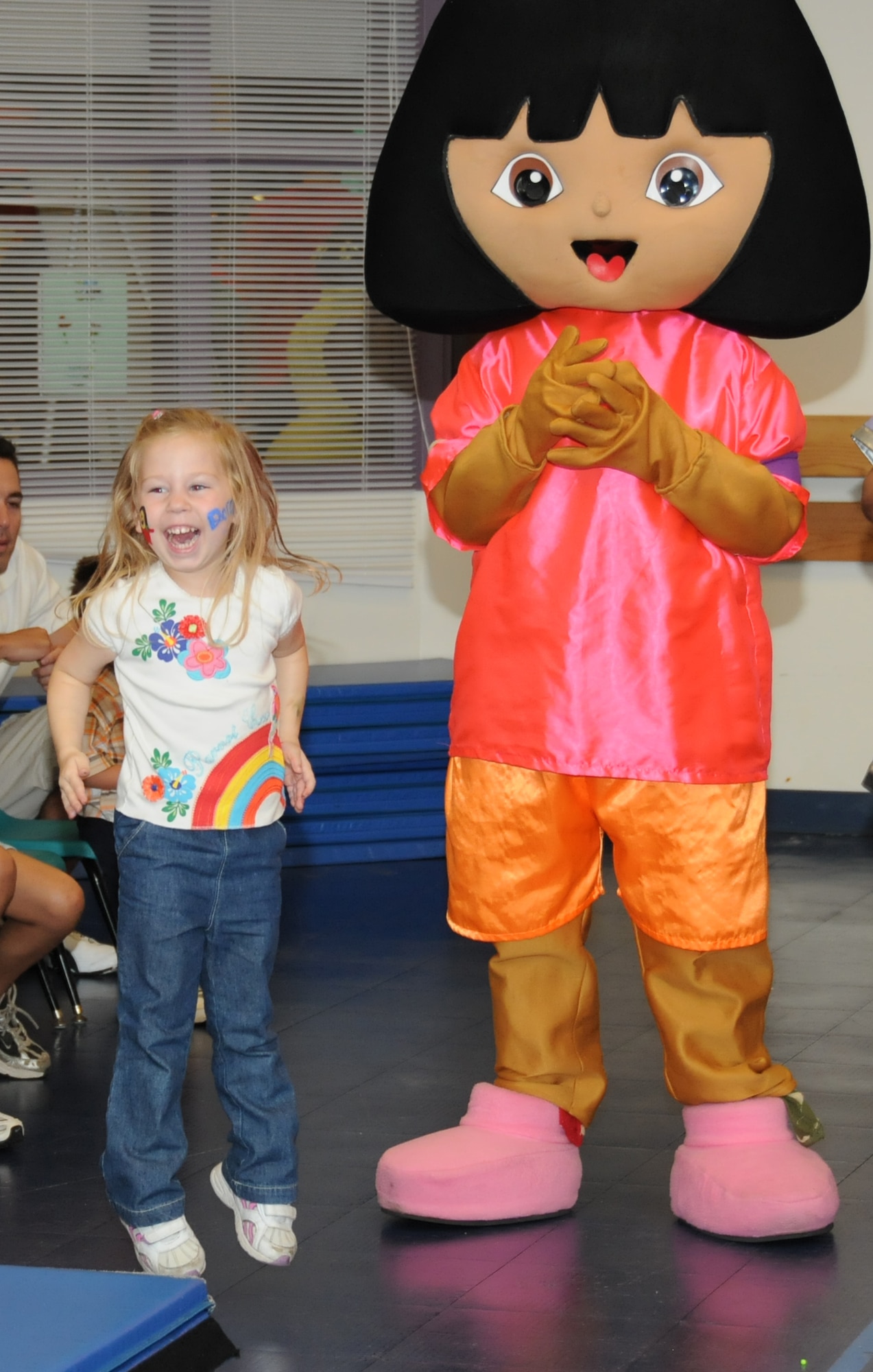 Sophie Stokes, 4, enjoys a dance with Dora the Explorer. Her grandmother is Col. Martha Ann Stokes, 81st Aerospace Medicine Squadron. (U.S. Air Force photo by Kemberly Groue)