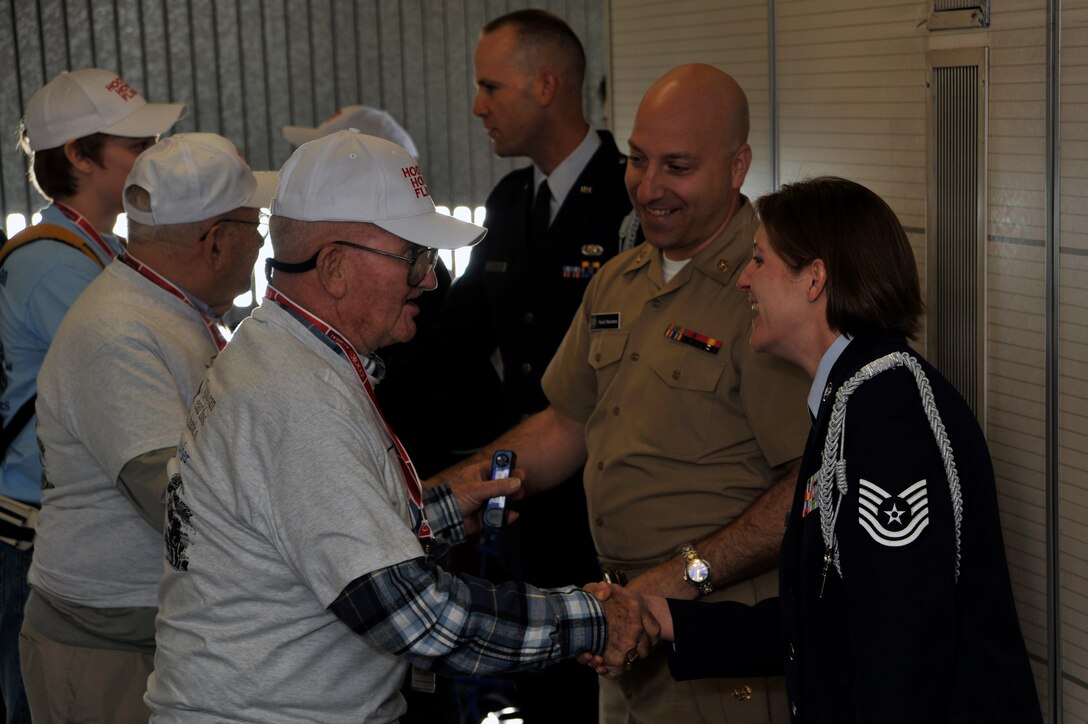 Military members from the National Capital Region greet World War II veterans at Ronald Reagan Washington National Airport in Arlington, Va., April 28, 2010. The 87 World War II veterans are here to visit the World War II memorial for the first time. The Honor Flight Network is a non-profit organization created to honor America's veterans by transporting them to Washington, D.C., for free to visit and reflect at their memorials. (U.S. Air Force photo by Airman 1st Class Perry Aston) (Released)
