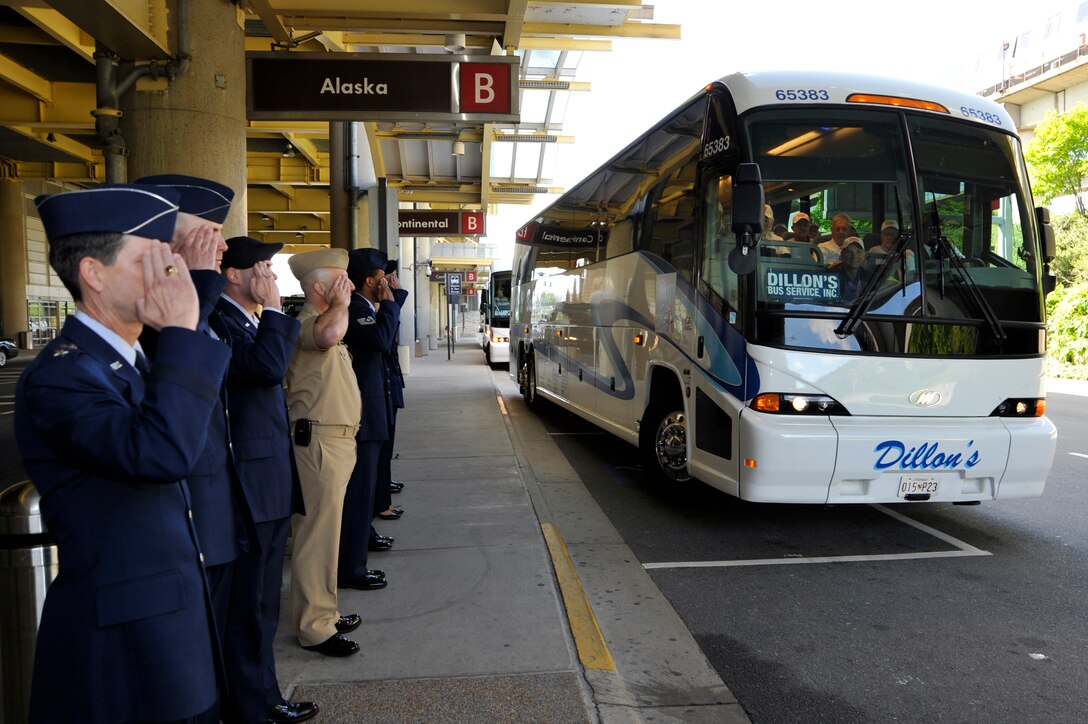 Maj. Gen. Darrell Jones, Air Force District of Washington commander, and other military members throughout the National Capital region salute WWII veterans as they depart from Ronald Reagan Washington National Airport in Arlington, Va. April 28, 2010. 87 World War II veterans are here to visit the WWII memorial for the first time. The Honor Flight Network is a non-profit organization created to honor America's veterans by transporting them to Washington, D.C. for free to visit and reflect at the WWII memorials. (U.S. Air Force photo by Airman 1st Class Perry Aston)
