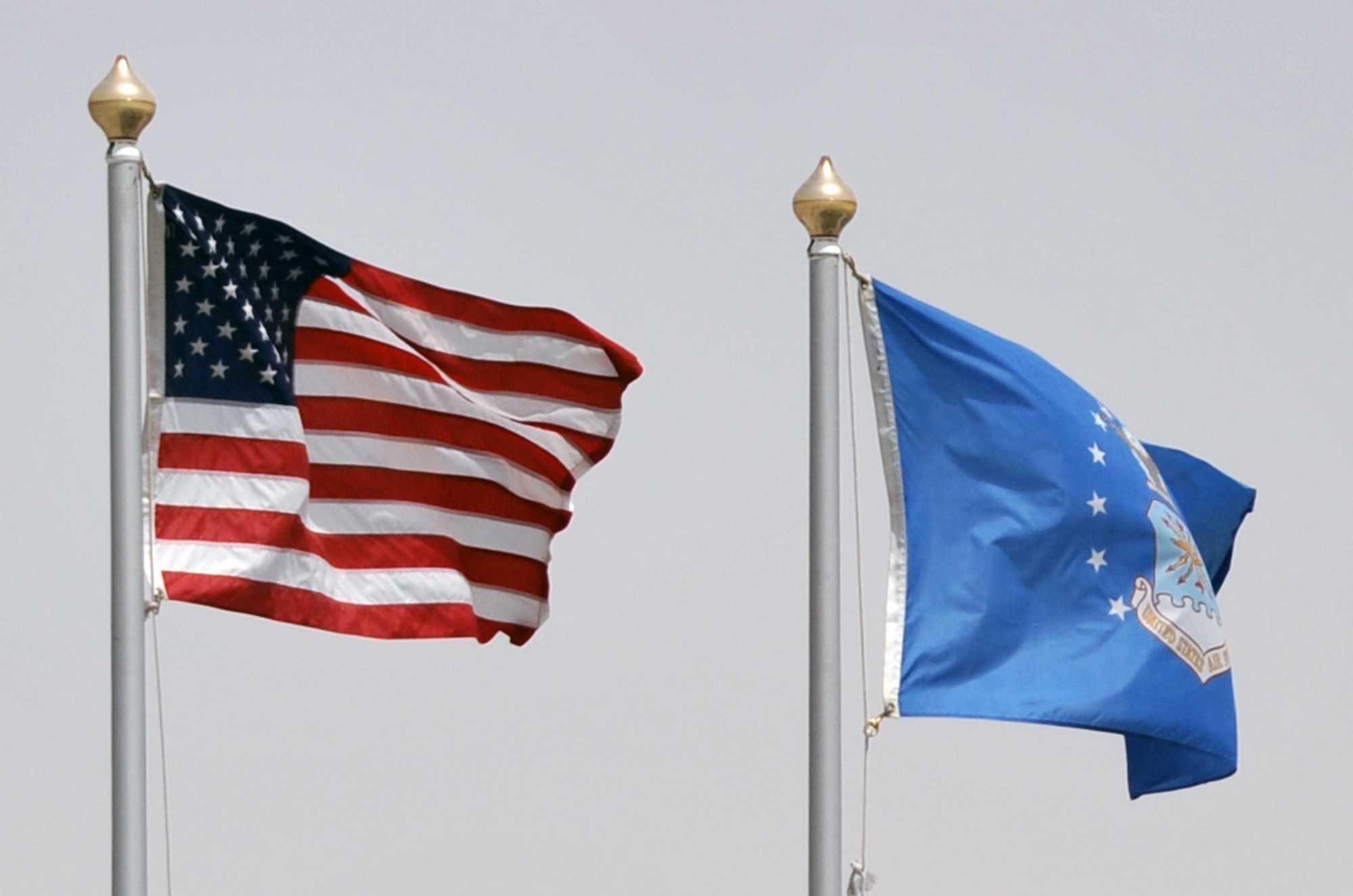 The American flag and the U.S. Air Force flag flies over the Sept. 11, 2001, memorial on the compound of the 380th Air Expeditionary Wing at a non-disclosed base in Southwest Asia on April 27, 2010. (U.S. Air Force Photo/Master Sgt. Scott T. Sturkol/Released)