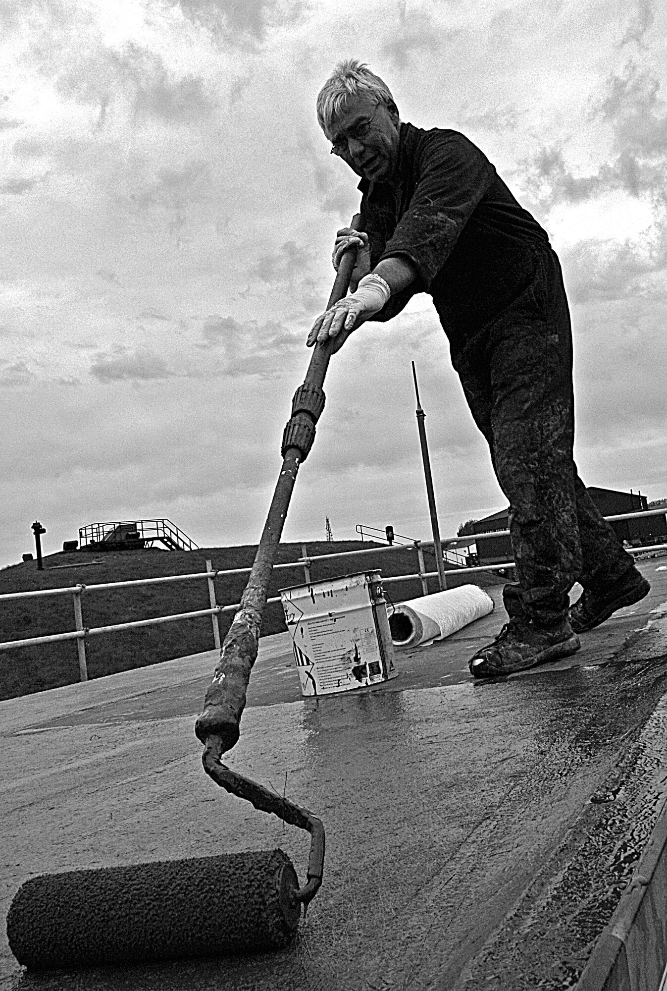 RAF MILDENHALL, England – Tom Farrington, a local contractor,  seals the roof of a storage facility here to prevent leaks or water damage April 29.  The roof repair is one of several construction projects underway around the base.  (U.S. Air Force photo/Staff Sgt. Christopher L. Ingersoll)