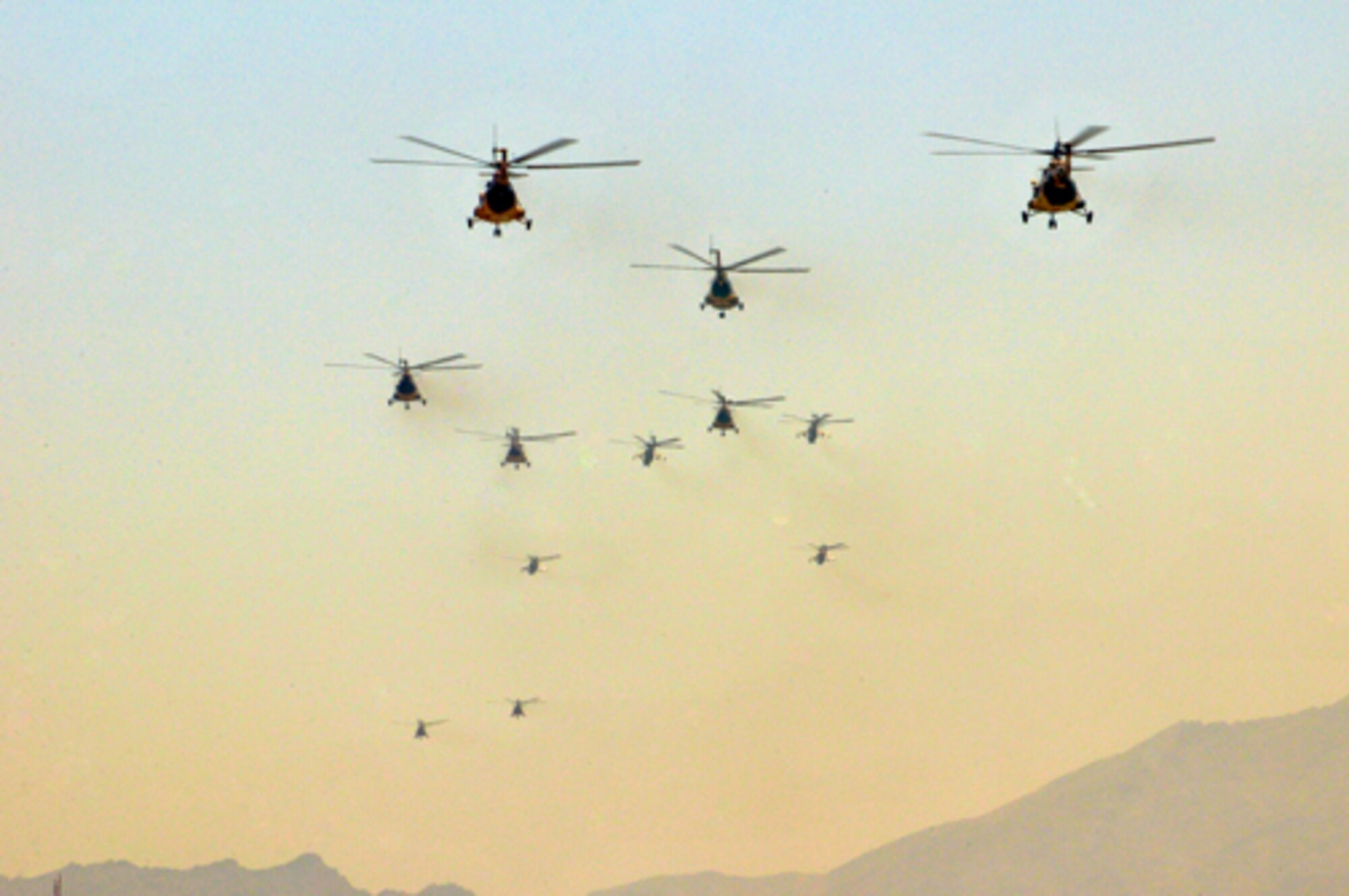 Mi-35 and Mi-17 helicopter aircrews fly in formation above Kabul, Afghanistan April 28, 2010. The formation was part of an air show held in celebration of the "Mujahedeen Victory Day". (US Navy photo by Mass Communication Specialist 2nd Class David Quillen/ RELEASED)