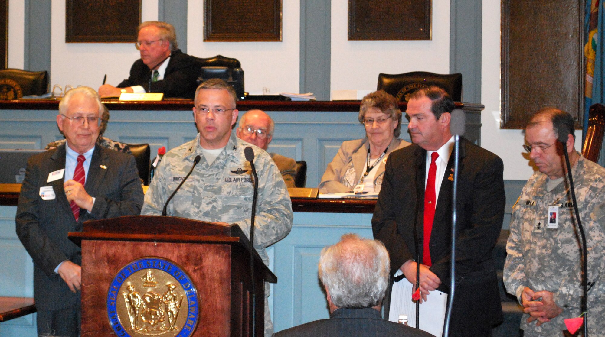 Col. Randal Bright, 512th Airlift Wing commander, thanks the Delaware House of Representatives at Legislative Hall, Dover, Del., April 27. The House of Representatives passed a resolution supporting the Employer Support of the Guard and Reserve. The purpose of the resolution was to raise awareness throughout the General Assembly of the need for civilian employer support of the men and women who serve in the Guard and Reserve. Delaware Rep. Earl G. Jaques, Jr., to the right of Colonel Bright, and Sen. George H. Bunting, Jr., not pictured, sponsored the ESGR Resolution. Retired Col. Gene Hebert, Delaware Committee of ESGR, and Army Maj. Gen. Francis D. Vavala, Adjutant General, Delaware, also attended the event and addressed the General Assembly. (ESGR photo/Christine Kubik)
