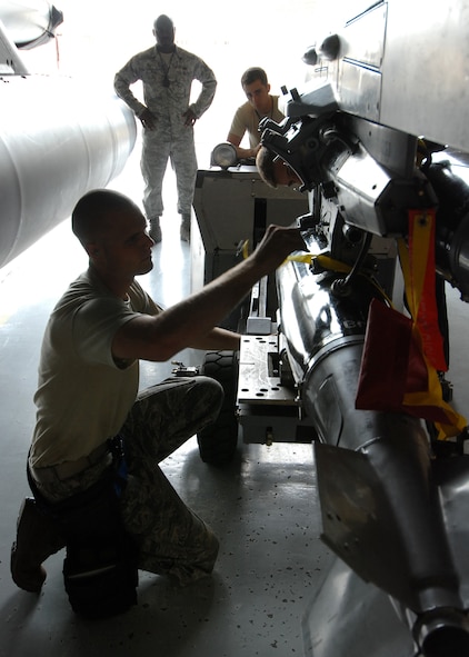TYNDALL AIR FORCE BASE, Fla. -- Staff Sgt. Jonathan Robertson, 309th Aircraft Maintenance Unit weapons load crew chief, works under watchful eyes while conducting monthly training to maintain his qualifications. The 325th Fighter Wing’s mission is to provide world-class training to guarantee air dominance for America. It accomplishes this objective by training F-15C Eagle and F-22 Raptor pilots and maintenance personnel.  The wing also conducts training for F-15 and F-22 intelligence officers, officer and enlisted air traffic controllers, and air battle managers all for the Combat Air Forces.  The 325th Fighter Wing has more than 3,000 personnel and an inventory of 53 F-15s and 29 F-22s. (U.S. Air Force photo/Tech. Sgt. Jeffrey A. Wolfe)