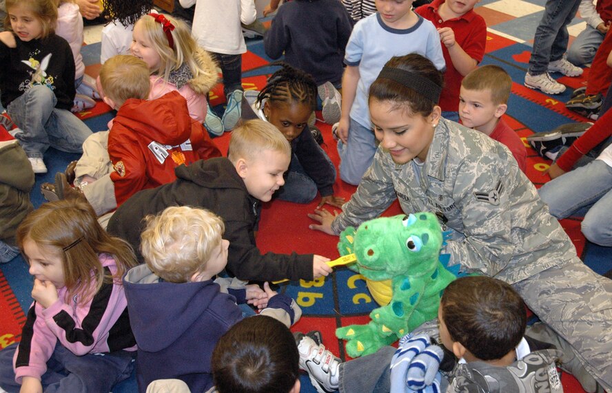 TYNDALL AIR FORCE BASE, Fla. -- Airman 1st Class Laura Lopez-Gardea, 325th Aeromedical-Dental Squadron dental assistant, shows Tyndall Elementary School Pre-K and Kindergarten students the proper way to brush teeth in February 2009. The 325th Fighter Wing’s mission is to provide world-class training to guarantee air dominance for America. It accomplishes this objective by training F-15C Eagle and F-22 Raptor pilots and maintenance personnel.  The wing also conducts training for F-15 and F-22 intelligence officers, officer and enlisted air traffic controllers, and air battle managers all for the Combat Air Forces.  The 325th Fighter Wing has more than 3,000 personnel and an inventory of 53 F-15s and 29 F-22s. (U.S. Air Force photo/Senior Airman Anthony J. Hyatt)