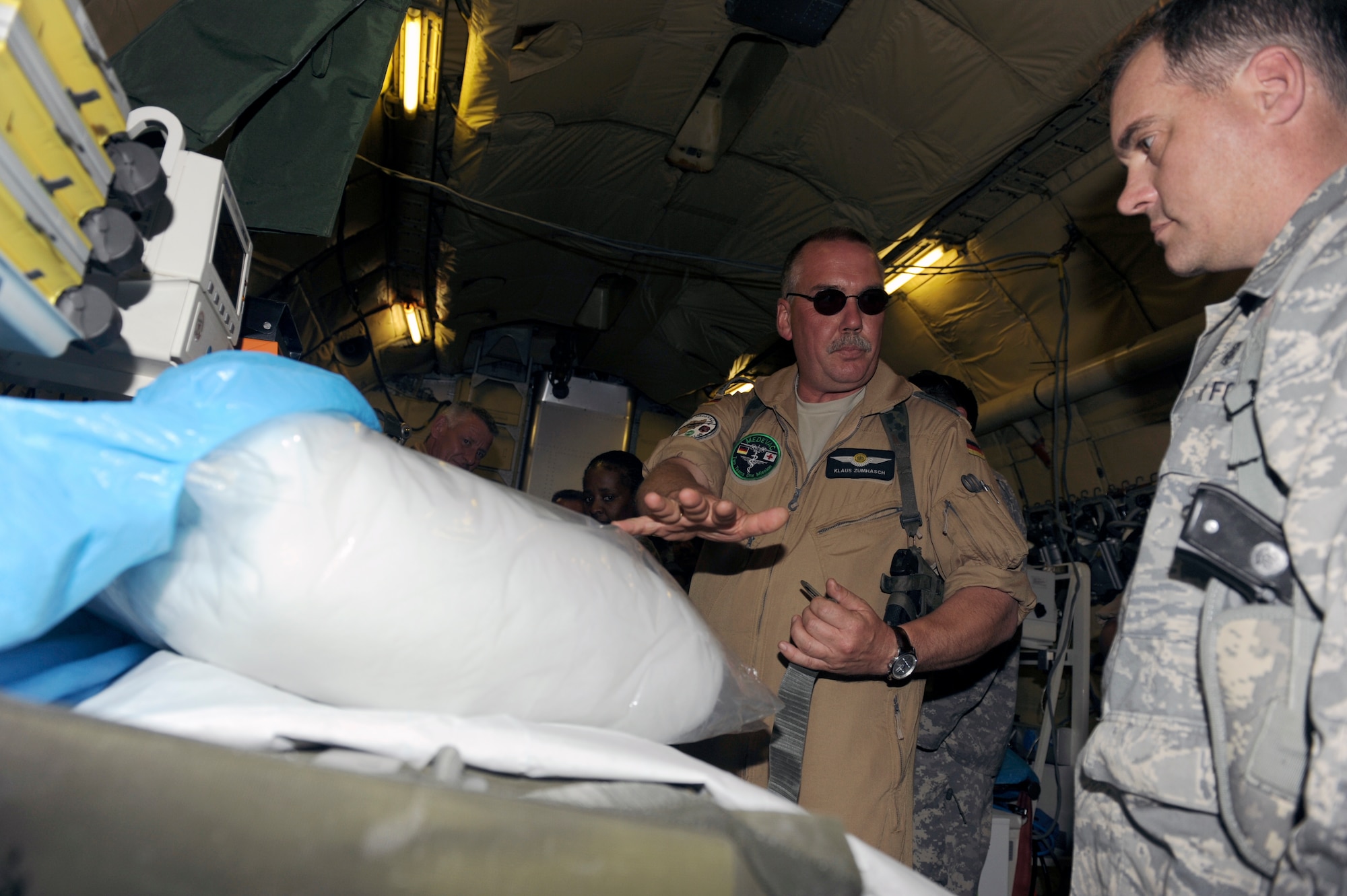 German military Chief Master Sgt Klaus Zuaihasch, a medical crew chief at Camp Marmal, Afghanistan, gives U.S. Air Force Lt. Col. Michael Gainer, commander, 455th Aeromedical Evacuation Flight a tour of a German C-160 aero medical evacuation aircraft, April 25, 2010. Colonel Gainer was visiting Camp Marmal to discuss the aeromedical evacuation mission in anticipation of the surge. (U.S. Air Force photo by/ Tech. Sgt. Jeromy K. Cross/released