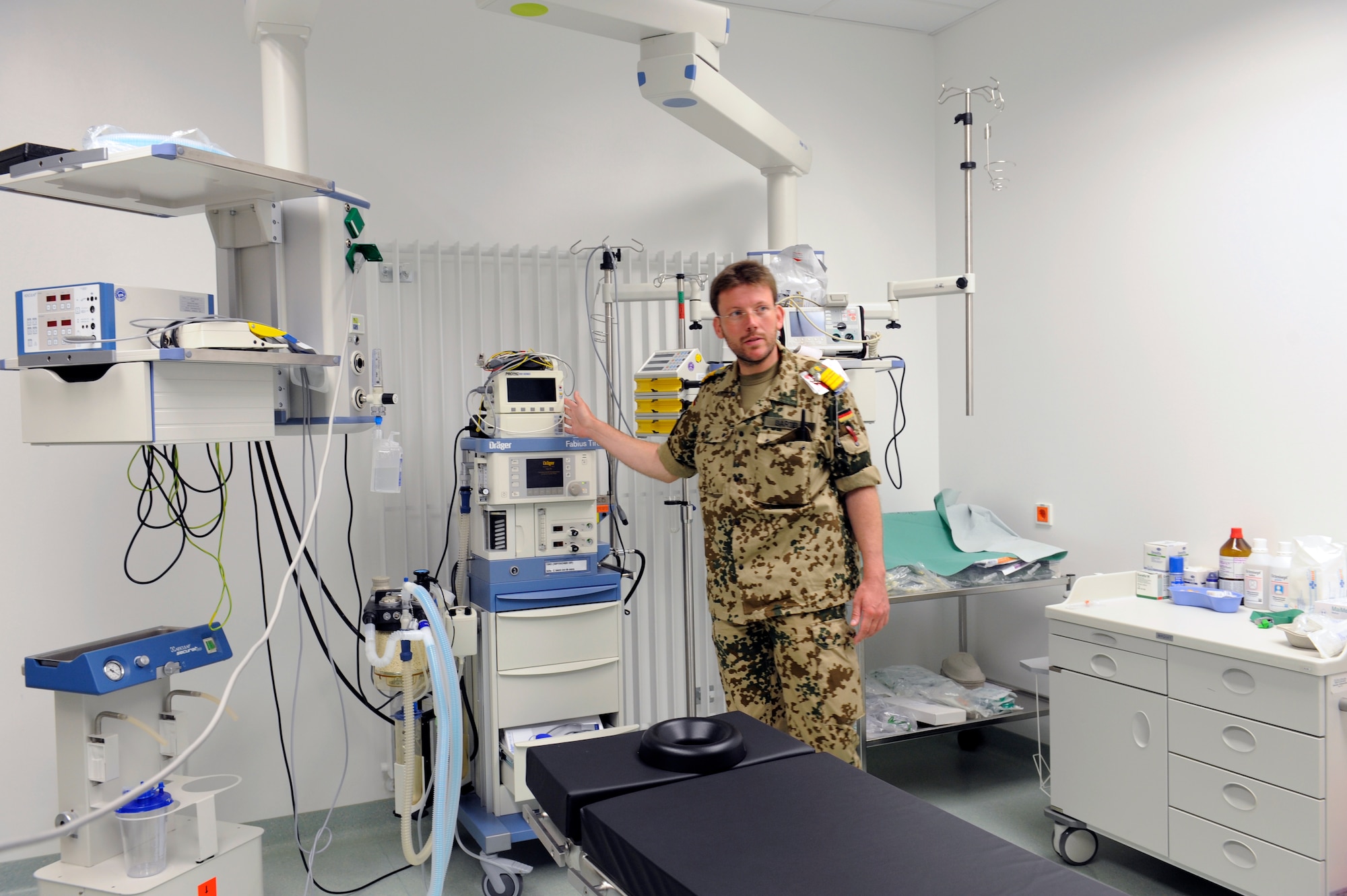 German military Lt. Col (Dr.) Frank Barteldt, commander of the medical treatment facility at Camp Marmal, Afghanistan, gives the commander of the 455th Expeditionary Aeromedical Evacuation Flight a tour, April 25, 2010. The 455th EAEF was visiting Camp Marmal to discuss the aeromedical evacuation mission in anticipation of the surge. (U.S. Air Force photo by/ Tech. Sgt. Jeromy K. Cross/released)