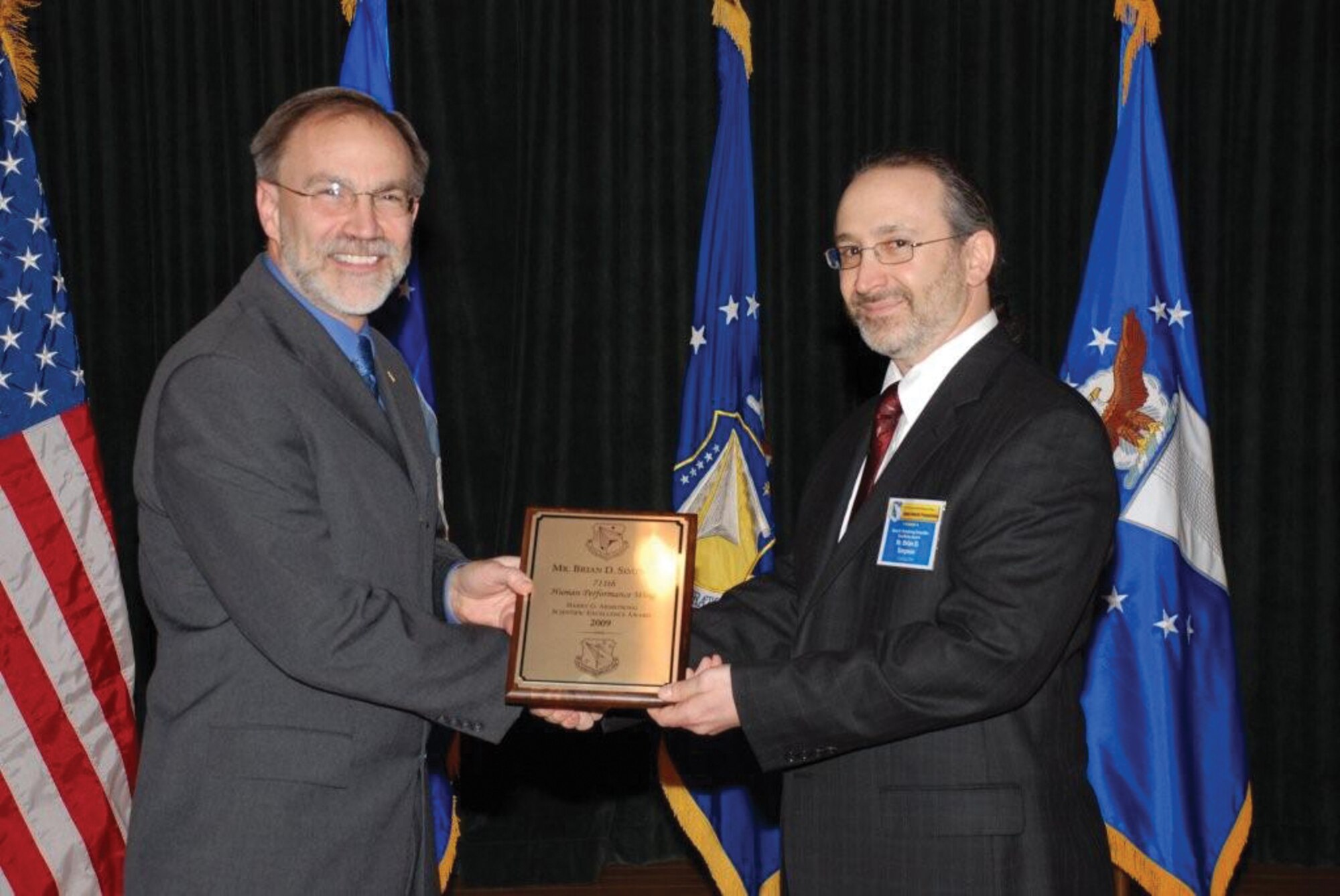Mr. Thomas Wells (pictured left), director of the Air Force Research Laboratory 711th Human Performance Wing, presents the 2009 Harry G. Armstrong Scientific Excellence Award to Mr. Brian Simpson, engineering research psychologist with the Human Effectiveness Directorate. (AFRL image)