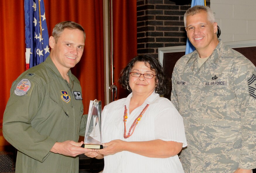 Terry Crawford of the 71st Logistics Readiness Squadron (center) 
receives the Longevity Award from 71st Flying Training Wing Commander Col. 
Chris Nowland (left) and 71st FTW Command Chief, Chief Master Sgt. Kenui 
Balutski (right) as part of Vance Air Force Base's Volunteer Excellence Award 
program. (U.S. Air Force photo/Angie Roche)
