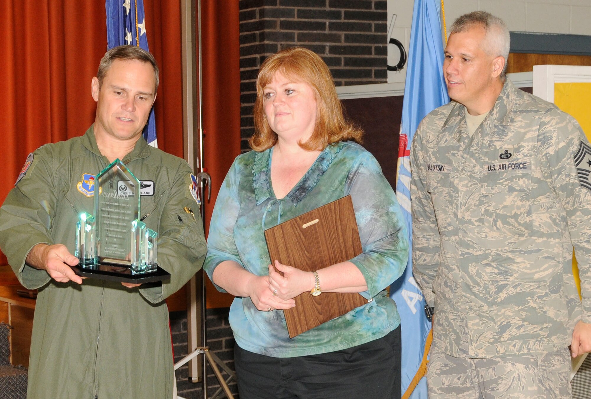 71st Flying Training Wing Commander Col. Chris Nowland presents the 
Volunteer Excellence Award to Kim Patton of the 71st Medical Support 
Squadron for her local area and military community volunteer work. The 71st 
FTW Command Chief, Chief Master Sgt. Kenui Balutski (right), looks on. (U.S. Air Force photo/Angie Roche)
