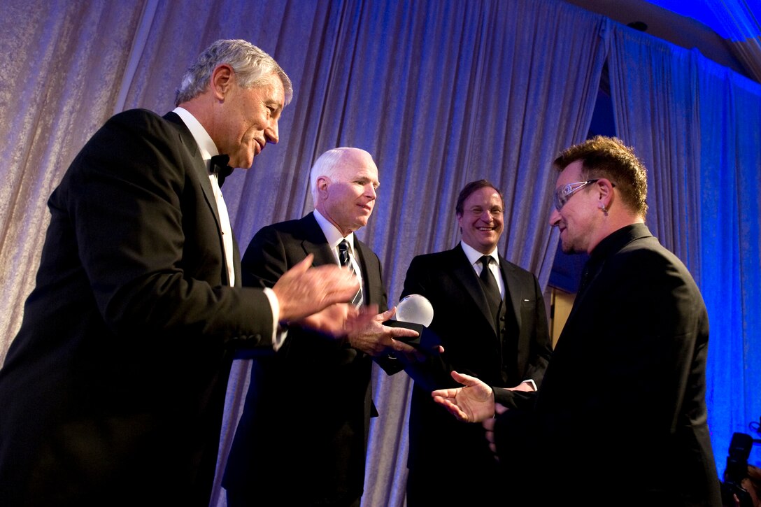 From left to right, U.S. Sen.Chuck Hagel, U.S. Sen. John McCain and Frederick Kempe, president, Atlantic Council, present Bono, rock star and activist, with the Distinguished Humanitarian Leadership Award at the annual Atlantic Council Awards Gala in Washington, D.C., April 26, 2010.