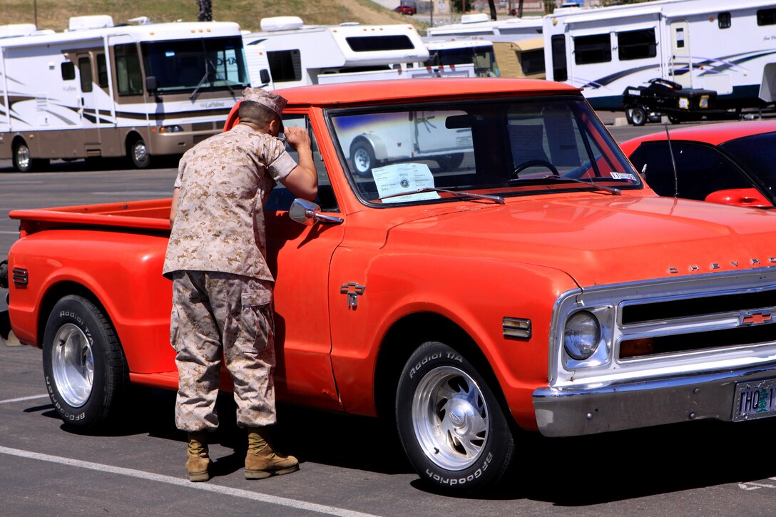 A Camp Pendleton Marine takes a closer look at one of the vehicles on sale at the base Resale Lot, April 29. Camp Pendleton officials recently issued BaseGram 21-10 to regulate the use of the base’s Resale Lot due to a rising number of illegally parked, stored and commercially sold vehicles.