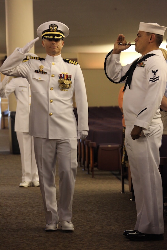 Navy Capt. John B. Burgess Jr., former commanding officer of Cherry Point’s Naval Health Clinic, approaches the stage during the Naval Health Clinic’s change of command ceremony, April 30. Burgess stepped down as the commanding officer and handed the reigns to Navy Capt. Edgardo Perez-Lugo, the new Naval Health Clinic commanding officer.