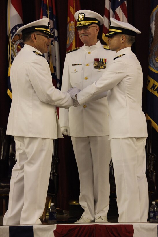 Navy Rear Adm. William R. Kiser, guest speaker for the Naval Health Clinic change of command, shakes hands with Navy Capt. John B. Burgess Jr., former commanding officer of Cherry Point’s Naval Health Clinic, during the ceremony, April 30. ::r::::n::“Capt. Lugo has big shoes to fill due to the big things Capt. Burgess has done for the clinic and for Marines and Sailors of Cherry Point,” said Kiser.::r::::n::