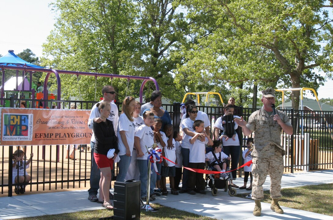 Col. Douglas Denn, the commanding officer of Marine Corps Air Station Cherry Point, speaks at the ribbon cutting ceremony for the grand opening of the Exceptional Family Member Program playground, here April 29. Designed to allow special needs children to have greater accessibility and for wounded warriors to play with their children, the playground enables the children to play to their fullest extent. The playground has a wheechair accessible swing, two infant-toddler swings and wheelchair accessible ramps to the elevated areas of the playground. The playground is a part of a $10 million effort to improve access for persons with special needs in 39 military installations, and this one is one of the firsts. Located in front of Lawson Village, the playground is open from dawn to dusk with parental supervision and is free to all families.
