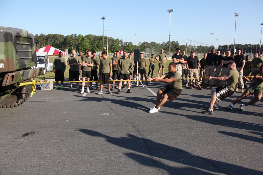 Marines and Sailors look on as Team Ram, representing Headquarters and Headquarters Squadron, pulls a seven-ton during a truck pull event for the Warrior’s Cup, April 30. Total, there were 13 teams competing that represented nine Cherry Point units. Marines and Sailors competed for first place and  prize of $700 for their unit’s picnic and party fund.
