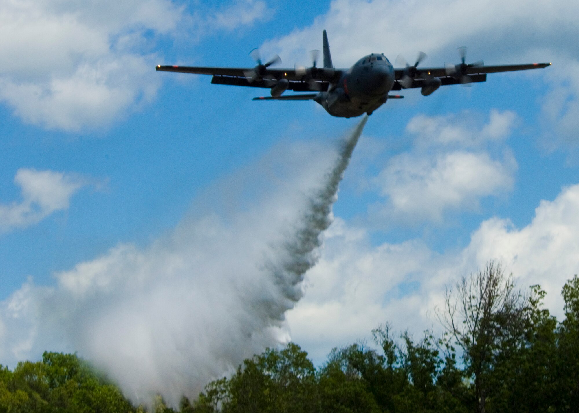 A C-130 from the 146th Airlift Wing located in Port Hueneme, Calif. drops water over the treetops in South Carolina. Modular Airborne Fire Fighting System, known as MAFFS, commenced annual training and certification this week in Greenville, S.C. April 26 to April 30, 2010. Photo by Airman 1st Class Nicholas Carzis