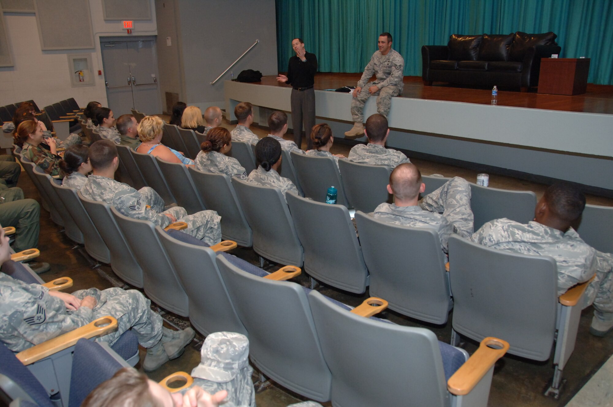 Mr. Mike Domitrz (standing) informally explains to the audience the benefits of asking to kiss someone during the final presentation of “Can I Kiss You?” held April 29 at the base theater. The focus of the show was to equip Airmen with the tools and knowledge they need to make dating easier while simultaneously avoiding sexual assaults. (U.S. Air Force photo by Senior Airman Nathan Allen)