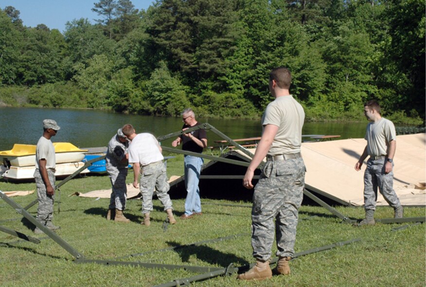Members from the 94th Airlift Wing volunteered their time and skills to set up for the 2010 Wing Family Day , which will be held May 1, starting at 11 a.m. at the Lakeside Recreation Facility, Building 537, softball field and surrounding park area. “There’s a lot of behind-the-scenes activity that goes into events such as this.” said Chief Master Sgt. Lester Davy, 22nd Air Force and member of the Dobbins Chiefs’ Group. “Family Day would not be a success without our volunteers. (U.S. Air Force photo/Travon Dennis)