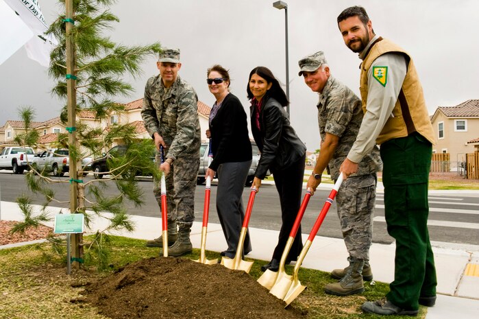 NELLIS AIR FORCE BASE, Nev. -- (left to right) Col. Steve Garland, 99th Air Base Wing, commander, Ms. Deborah Stockdale, 99th Civil Engineer Squadron, Chief, Asset Management, Ms. Susan Breckon, Hunt Military Communities, Col. Kevin Fox, 99th Mission Support Group, commander and Mr. Matthew Koepnick, Nevada Division of Forestry, break ground at the Landings at Nellis to plant a new tree in celebration of  Arbor Day Proclamation 2010. On April 29th, Nellis was acknowledged by the National Arbor Day Foundation for its beautiful trees and its continual dedication to environmental improvement.  (U.S. Air Force Photo / Airman 1st Class Jamie Nicley)