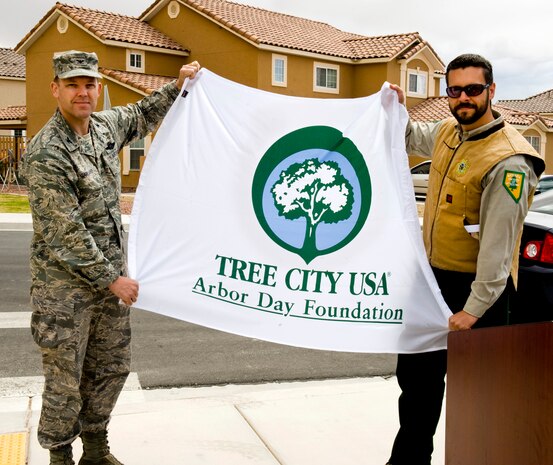 NELLIS AIR FORCE BASE, Nev. -- Col. Steve Garland, 99th Air Base Wing, commander, receives the Tree City USA Award from Mr. Matthew Koepnick, Nevada Division of Forestry, April 29, 2010.  Nellis has won the award for the past 16 years for the installation's commitment to the development of renewable energy through the development of solar power, energy conservation and wise use of our natural resources.  The Tree City USA program provides direction, technical assistance, public attention, and national recognition for urban and community forestry programs throughout the United States. (U.S. Air Force Photo / Airman 1st Class Jamie Nicley)

