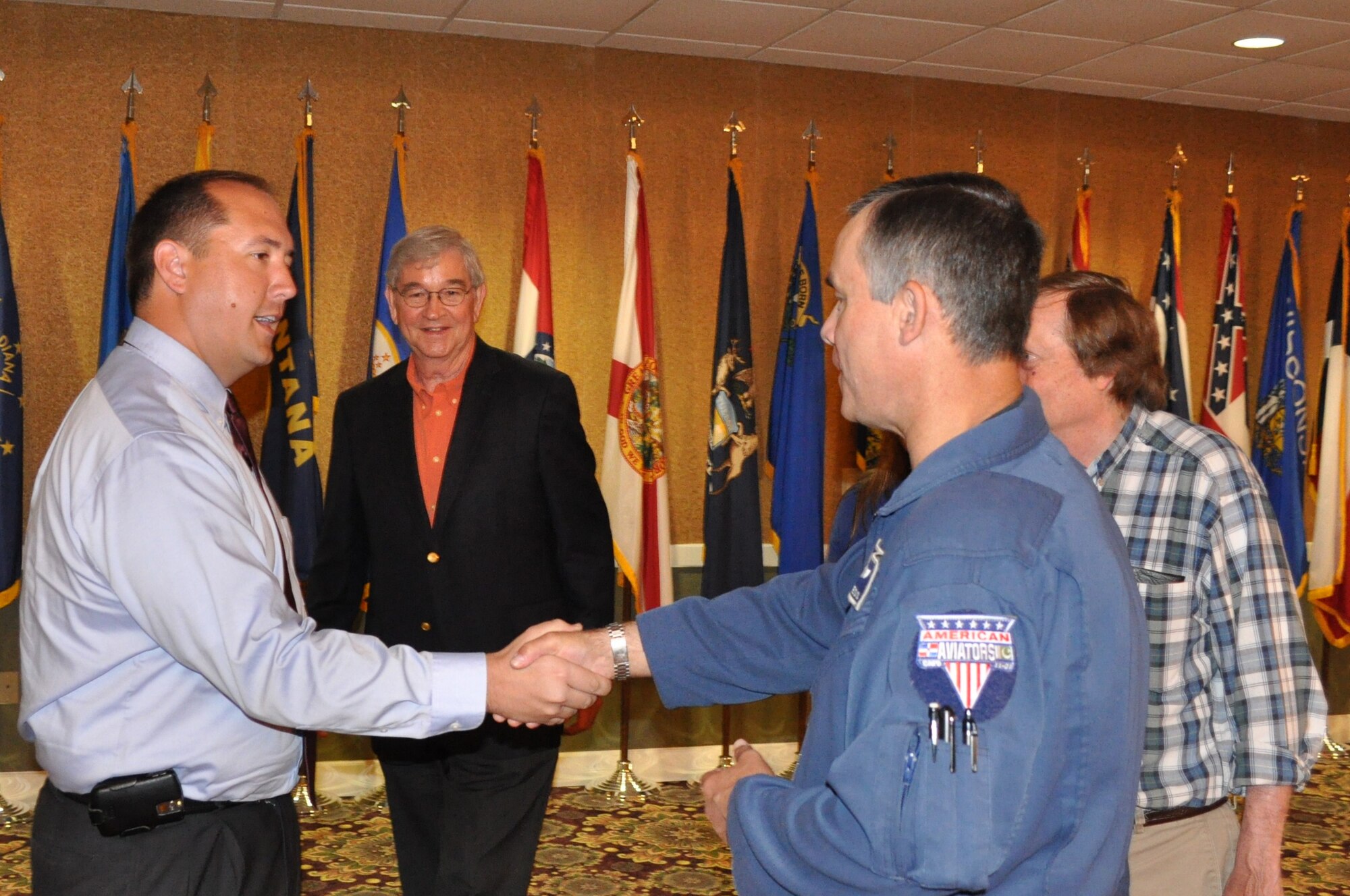 Kevin Stafford, newly elected president of the Base Community Council, is congratulated by returning vice president retired Col. Buck Burgess Apr 23. The BCC held its quarterly meeting Friday where they received an Air Show update and elected new officers. Joining Stafford is Colonel Burgess, Vice President, Brenan Dulaney, Secretary and Rufus Ward, Treasurer. (US Air Force Photo by Senior Airman Jacob Corbin)